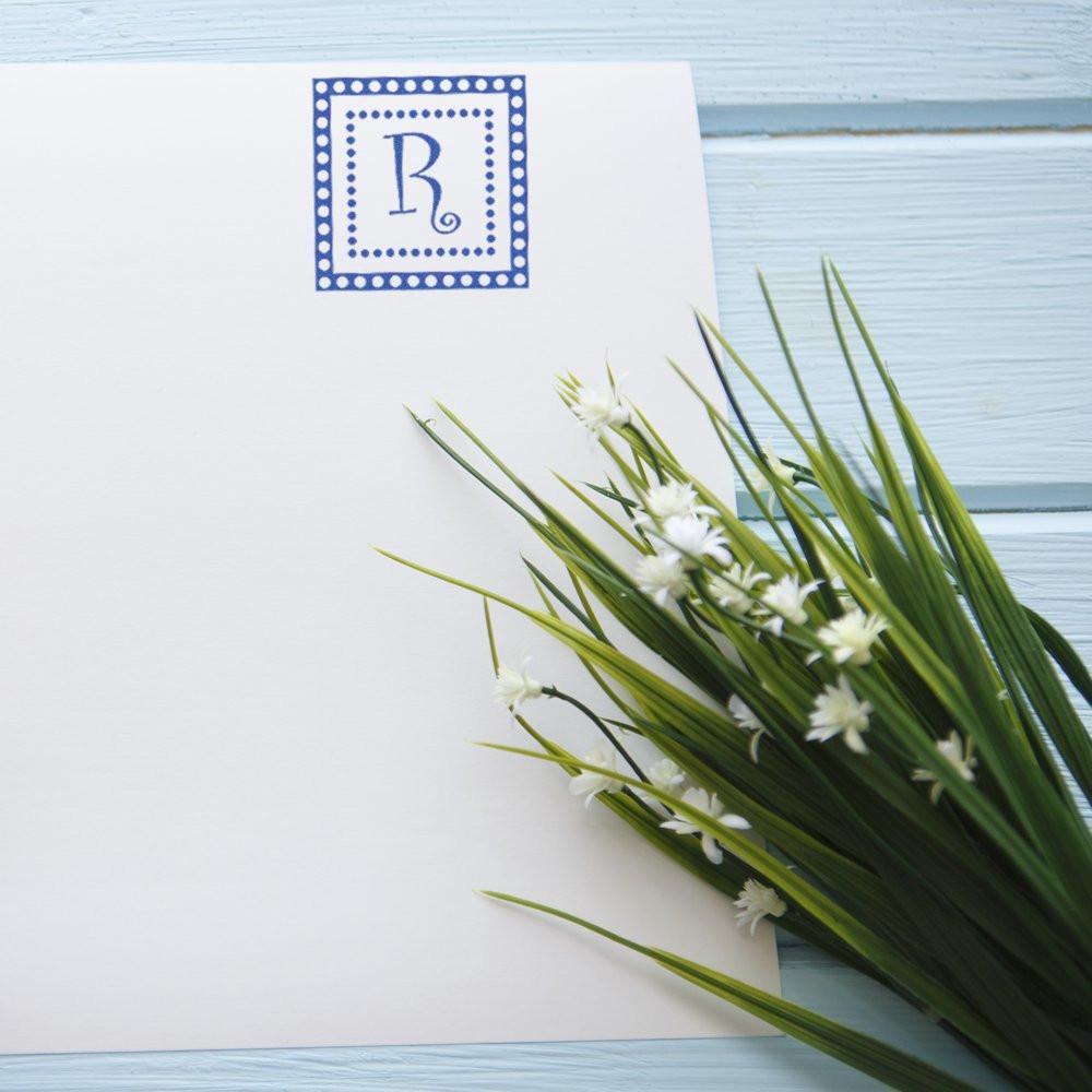 Personalized monogram rubber stamp with blue letter R on stationery, ideal for custom wedding invitations and cards