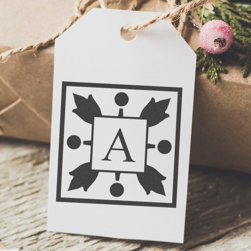 Monogram rubber stamp design with letter A on a personalized gift tag for weddings and packaging.