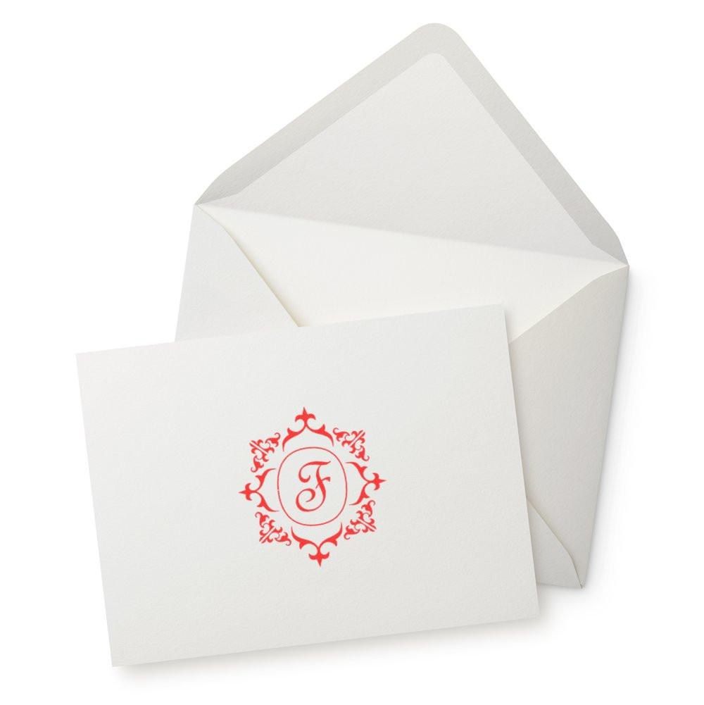 Custom monogram rubber stamp with ornate red F for wedding invitations and envelope stationery.