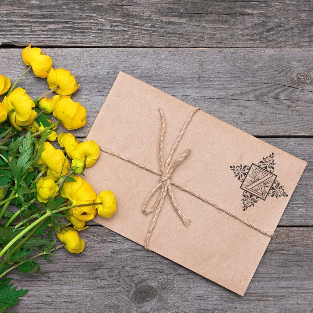 Decorative floral rubber stamp on a kraft paper envelope, ideal for rustic handmade gift packaging and stationery.