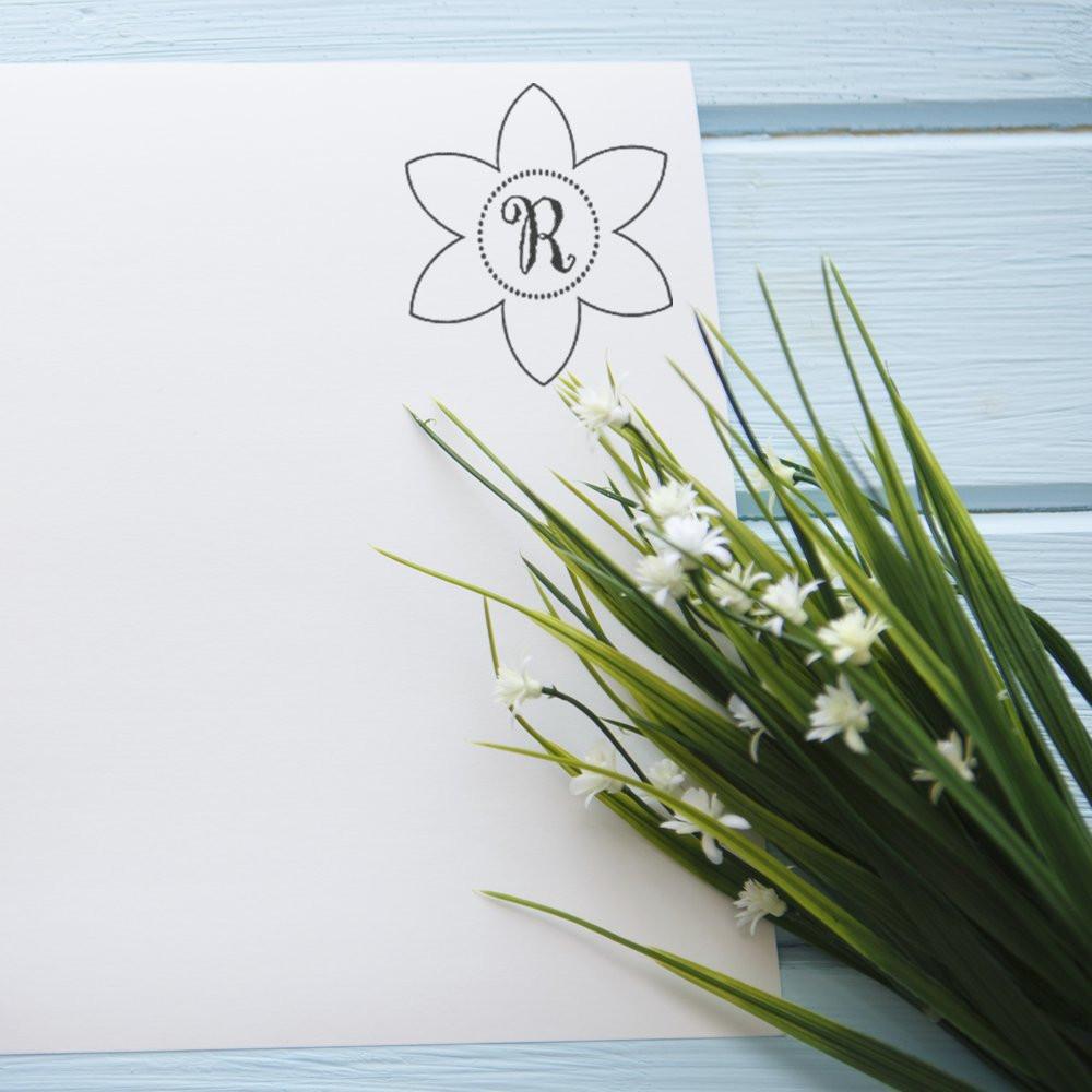 Custom floral monogram R rubber stamp on white paper, perfect for wedding invitations, stationery, and handmade branding.