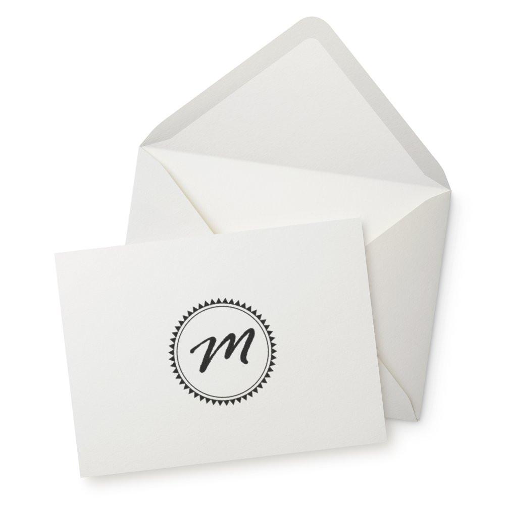 Custom monogram rubber stamp on white envelope and card for personalized stationery branding