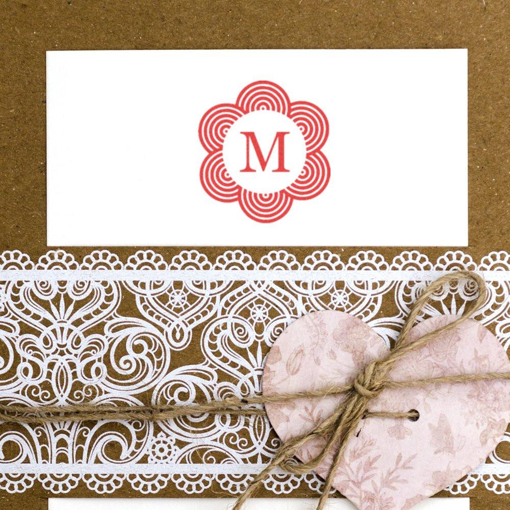 Custom monogram rubber stamp with floral red M on handmade cardstock, lace trim, and heart gift tag.