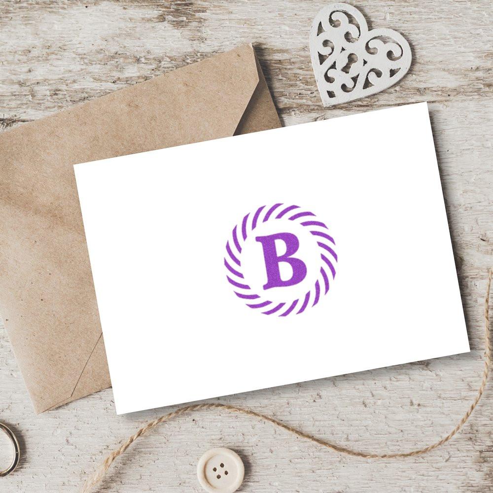 Custom purple monogram B rubber stamp on blank greeting card with envelope, showcasing personalized stamp design.