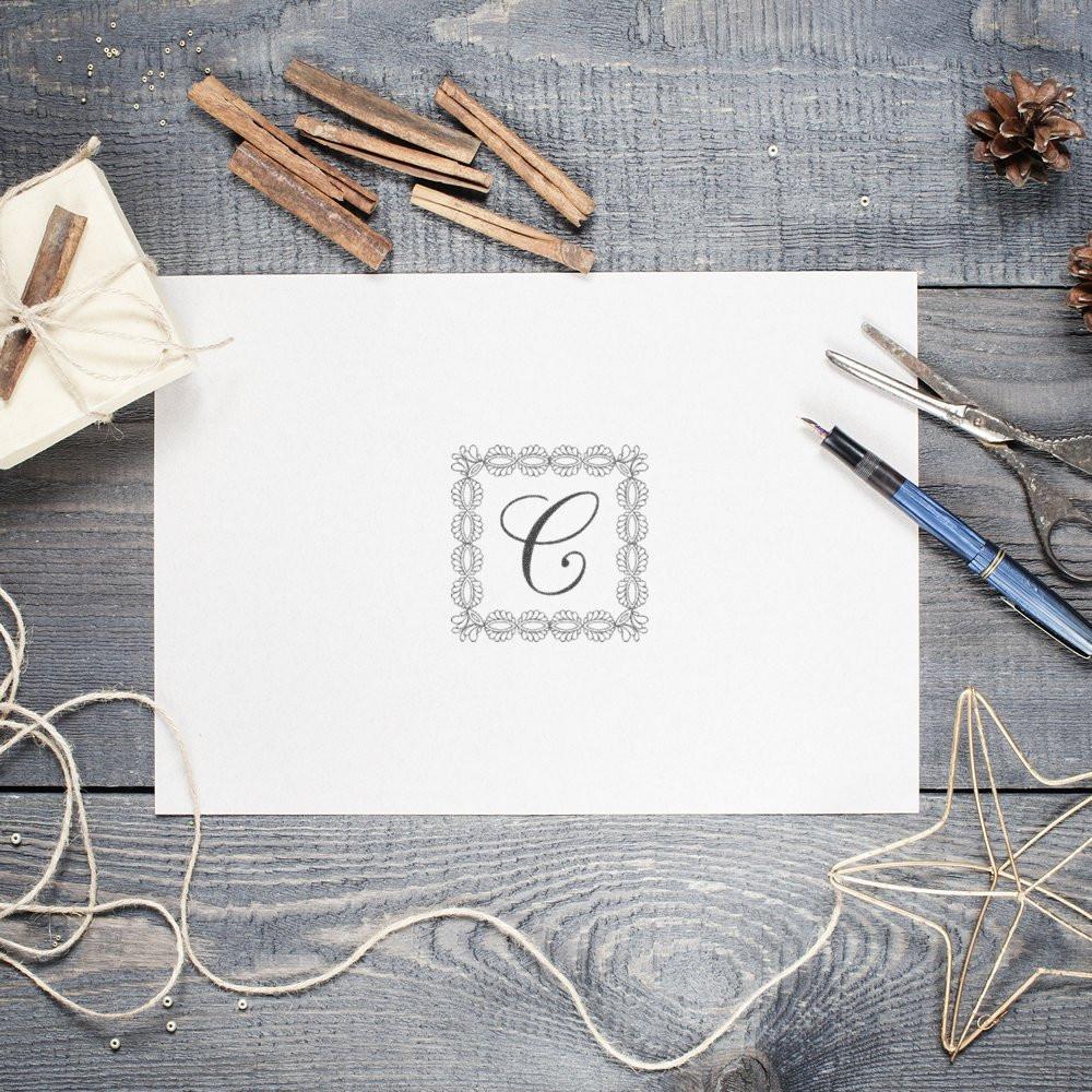 Custom monogram rubber stamp with floral border, perfect for personalized wedding invitations and stationery.