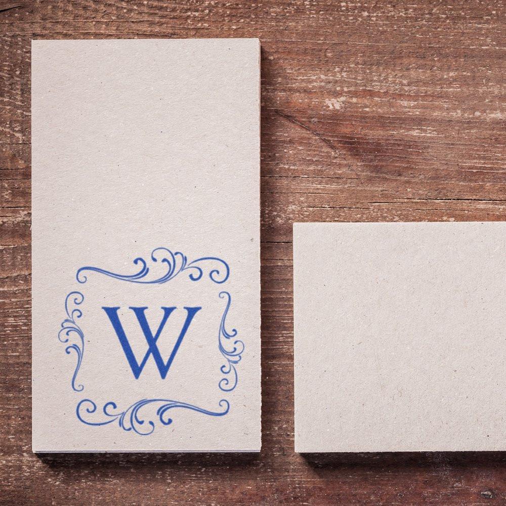 Custom blue monogram W rubber stamp on textured cardstock with ornate border, ideal for personalized stationery.