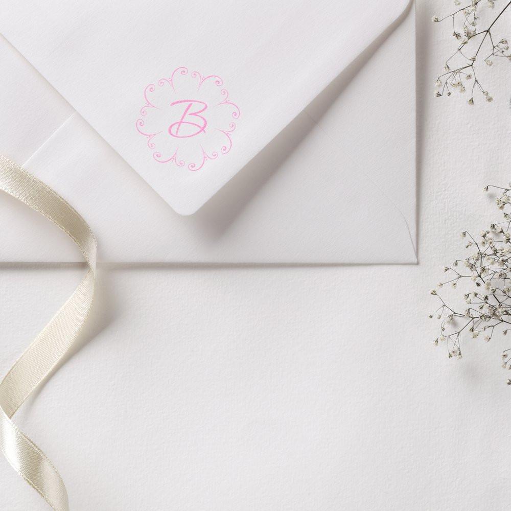 Custom monogram rubber stamp on white wedding envelope with pink floral B