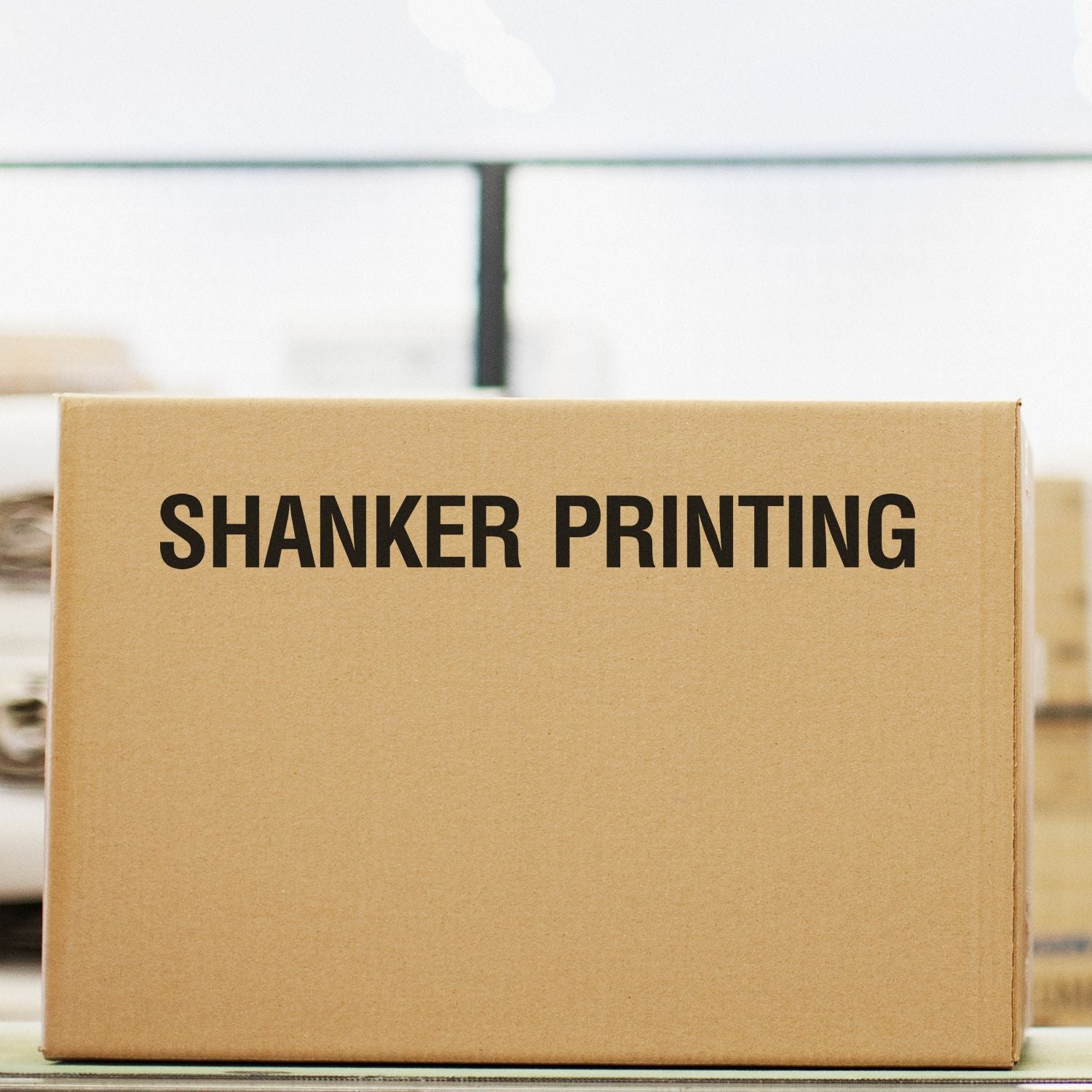 Cardboard shipping box for Shanker Printing, showcasing branded packaging for print delivery and logistics.