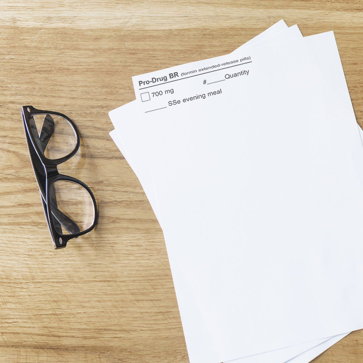 Pro-Drug BR 700 mg extended-release pill prescription instructions for evening meal on paper with eyeglasses.