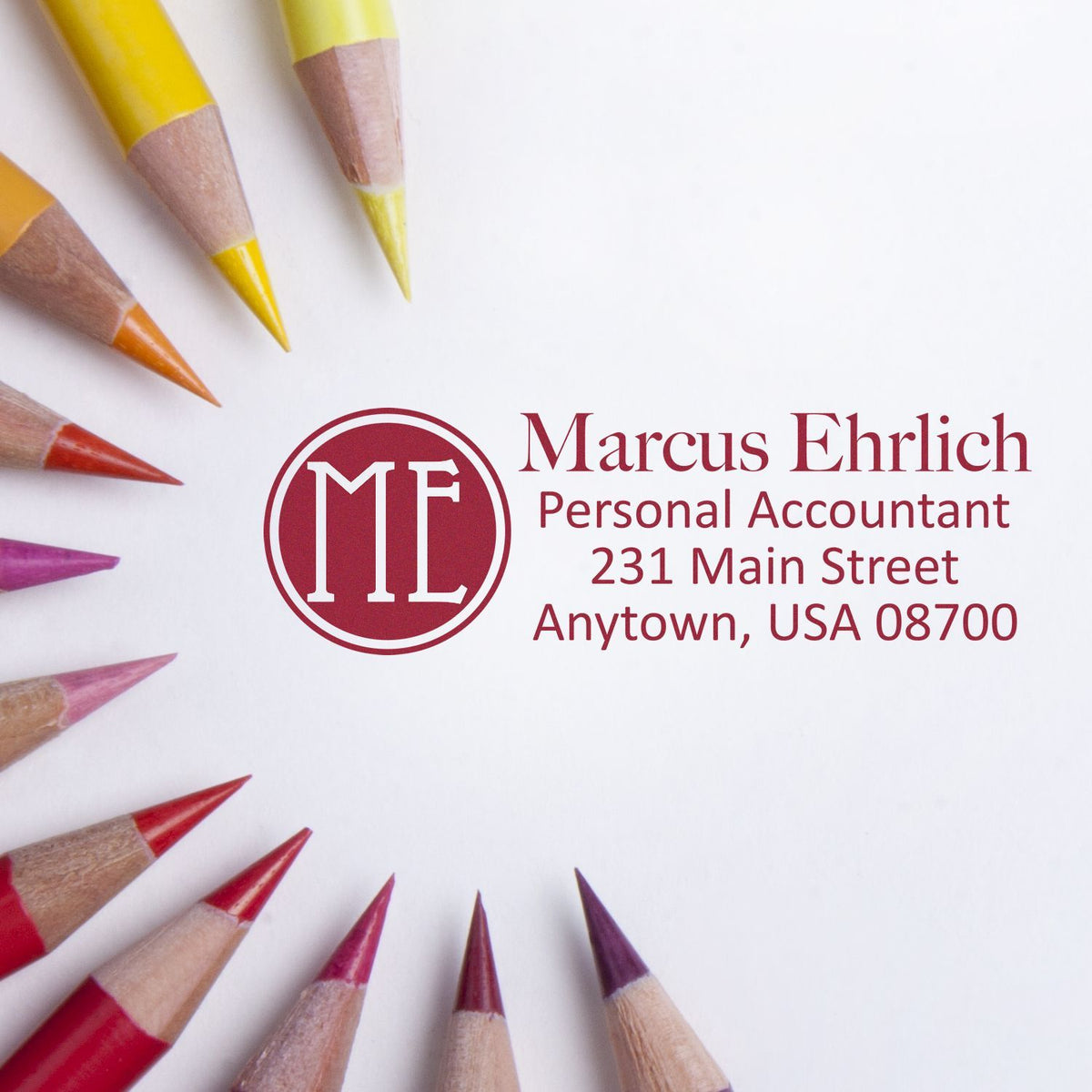 Colored pencils around a Marcus Ehrlich personal accountant business card with logo, name, address, and contact details on a white background.