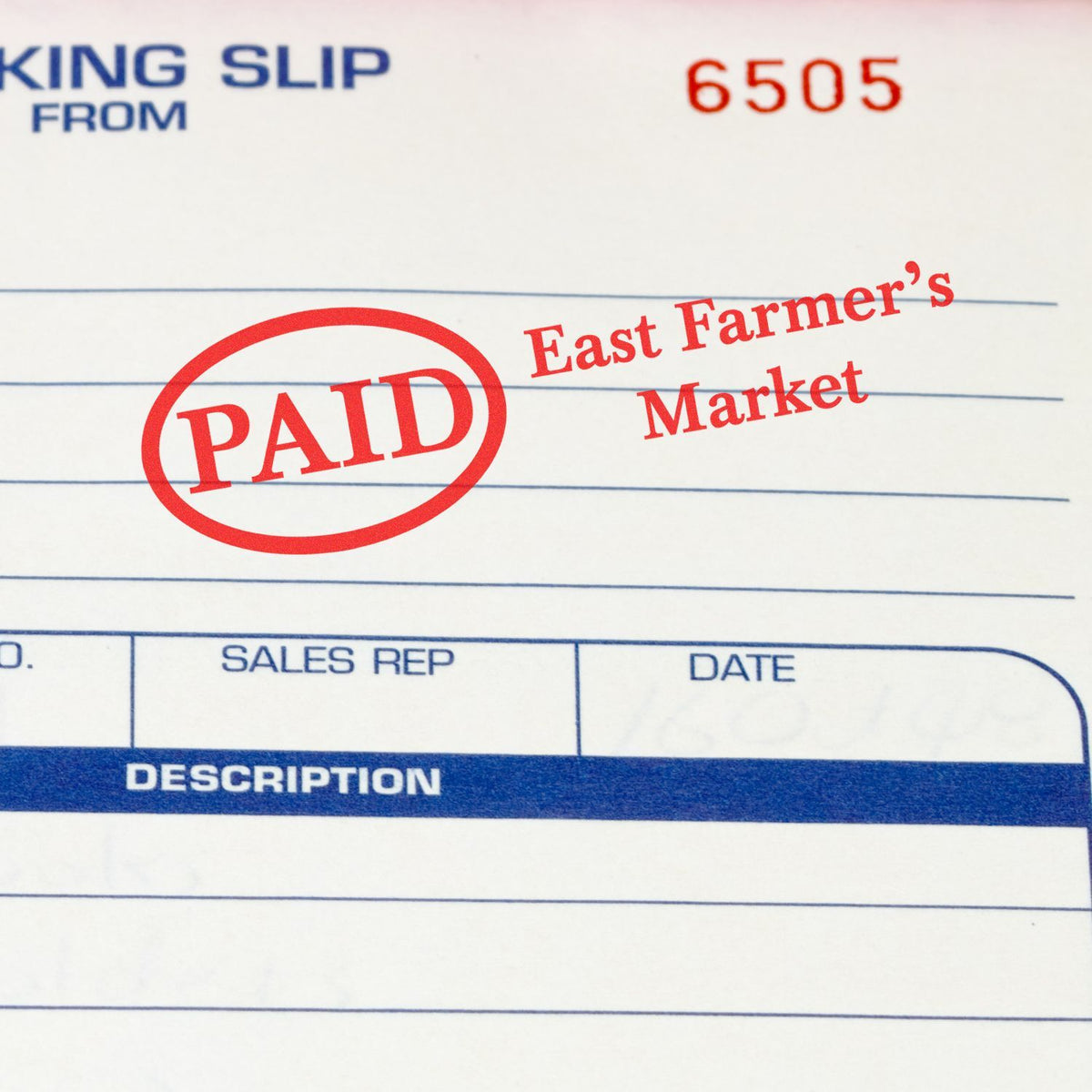 Document showing red PAID stamp for East Farmers Market, confirming payment status on sales form.