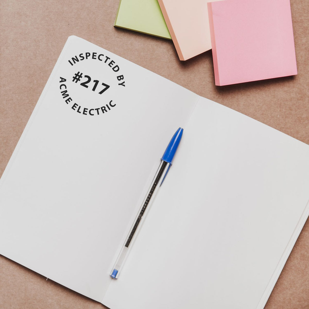 Inspected Acme Electric report #217 notebook with pen and folders, highlighting electrical inspection documentation.