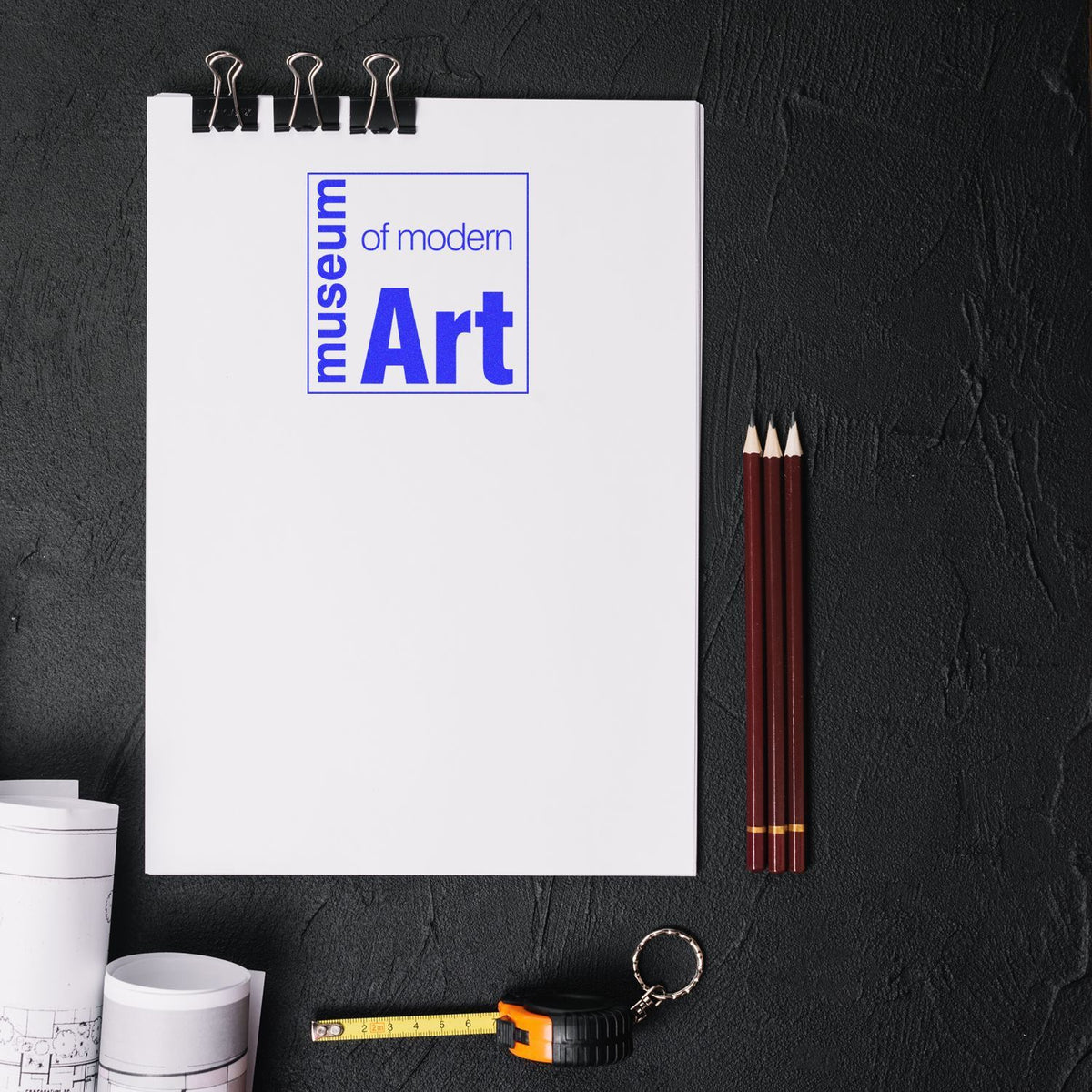 Modern art inspiration flatlay: Museum of Modern Art notebook with blank page, pencils and tape measure for design planning creativity