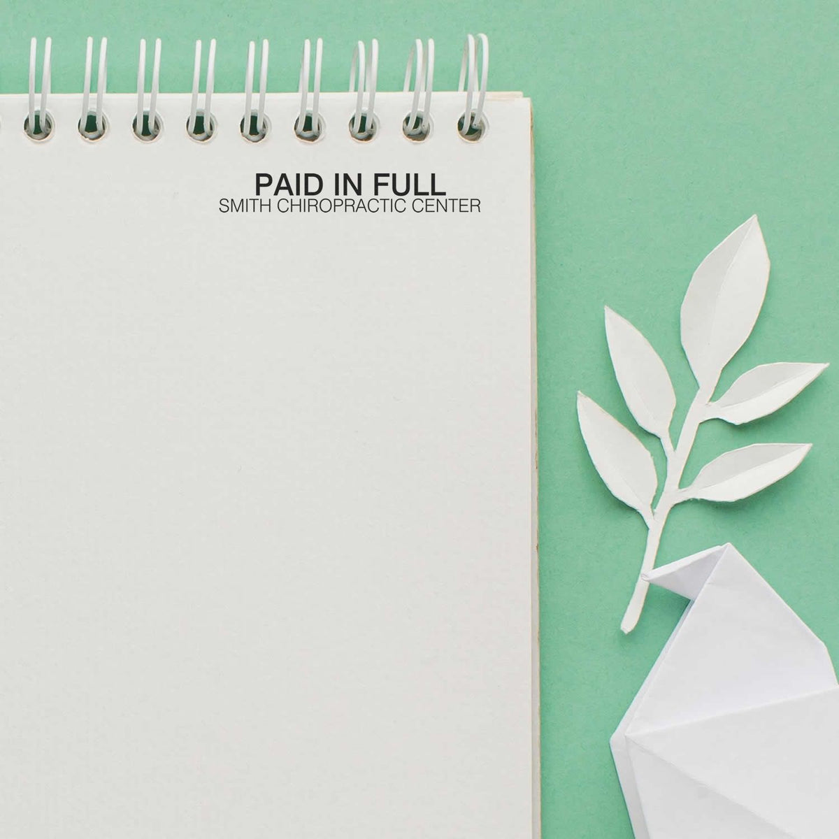 Paid in Full note from Smith Chiropractic Center on notebook cover, promoting chiropractic settlement and patient payment status.