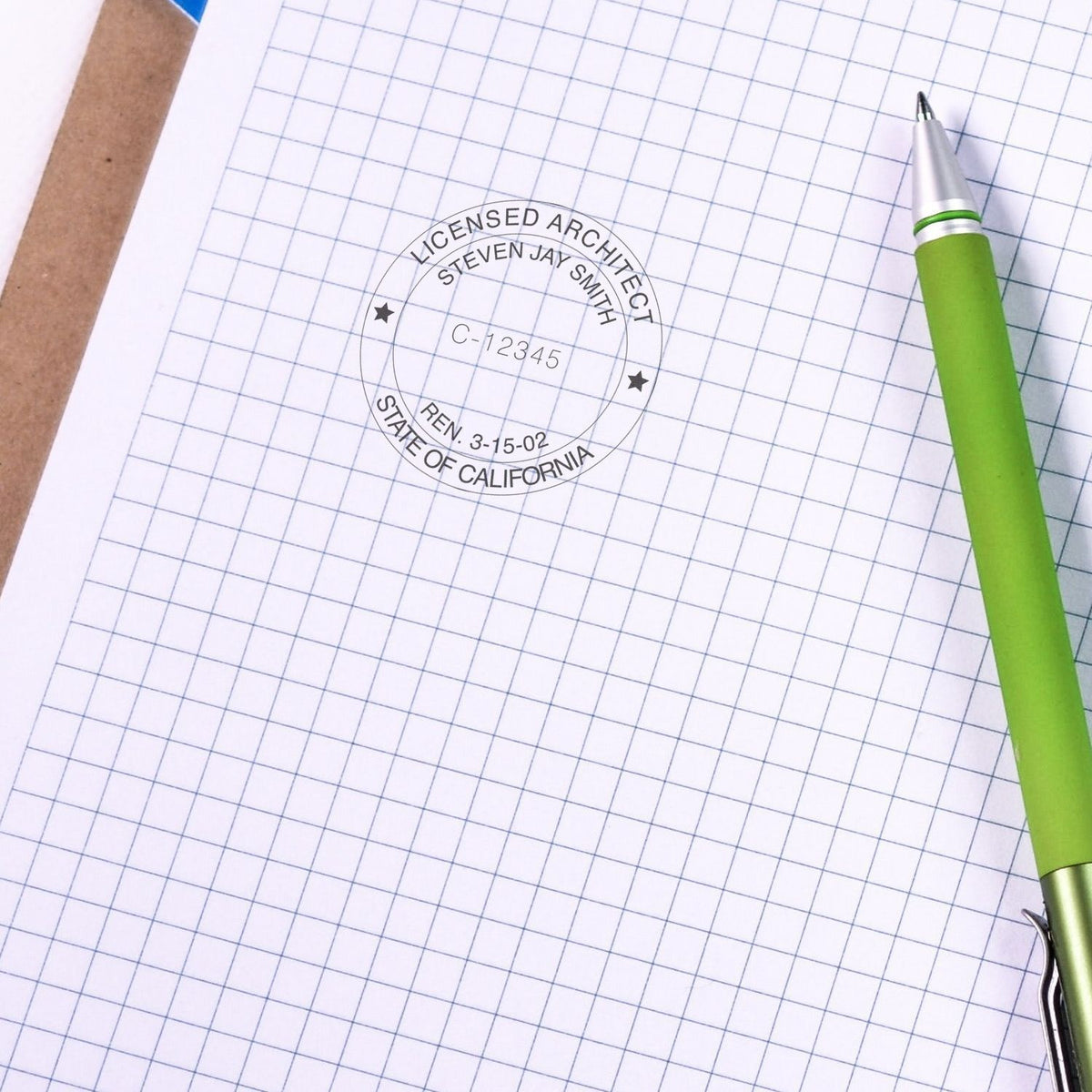 Licensed architect stamp on blueprint paper for California, with green pen, representing professional architecture licensing credential.