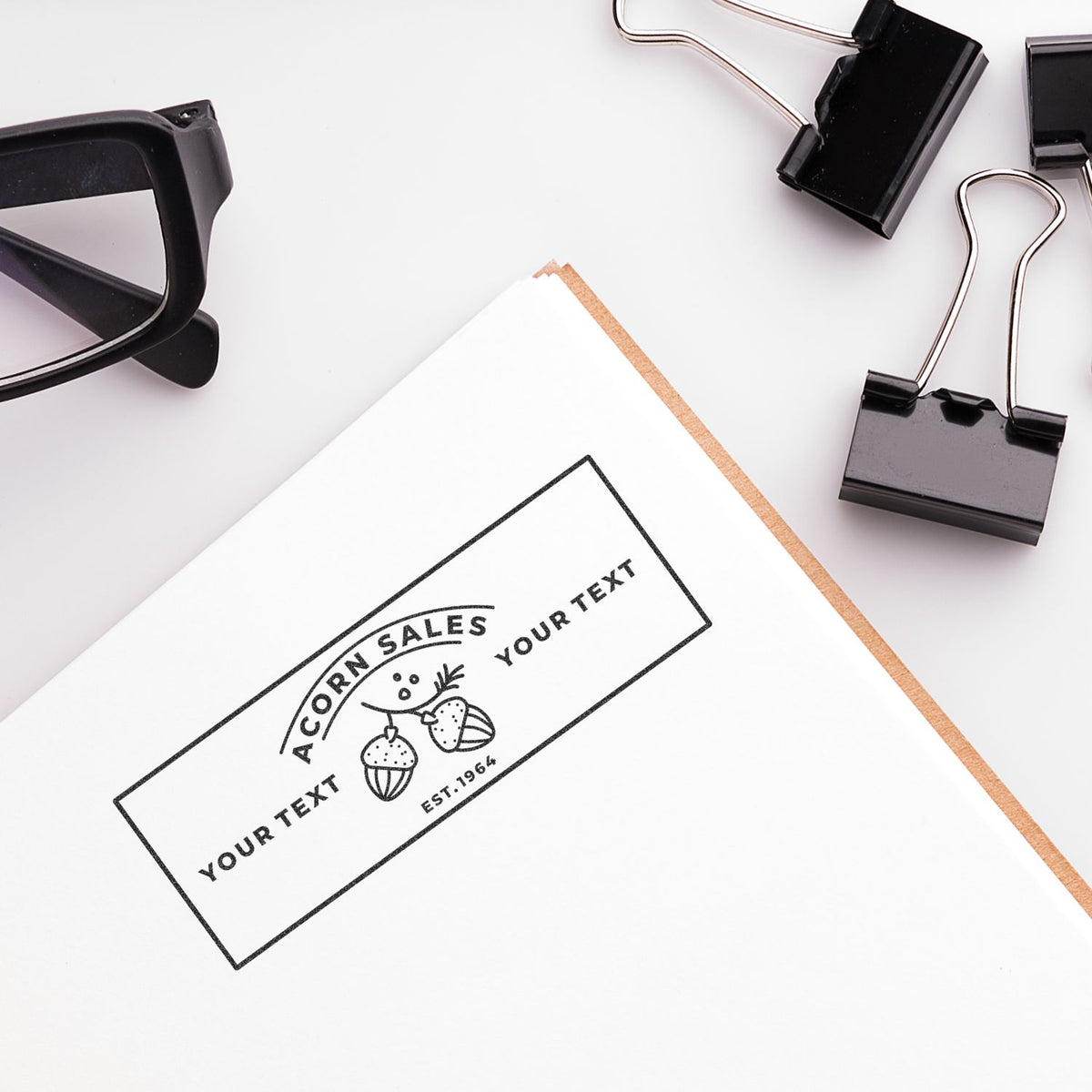 Branding mockup: logo label on white paper with office supplies like sunglasses, binder clips, and clipboard for marketing design.