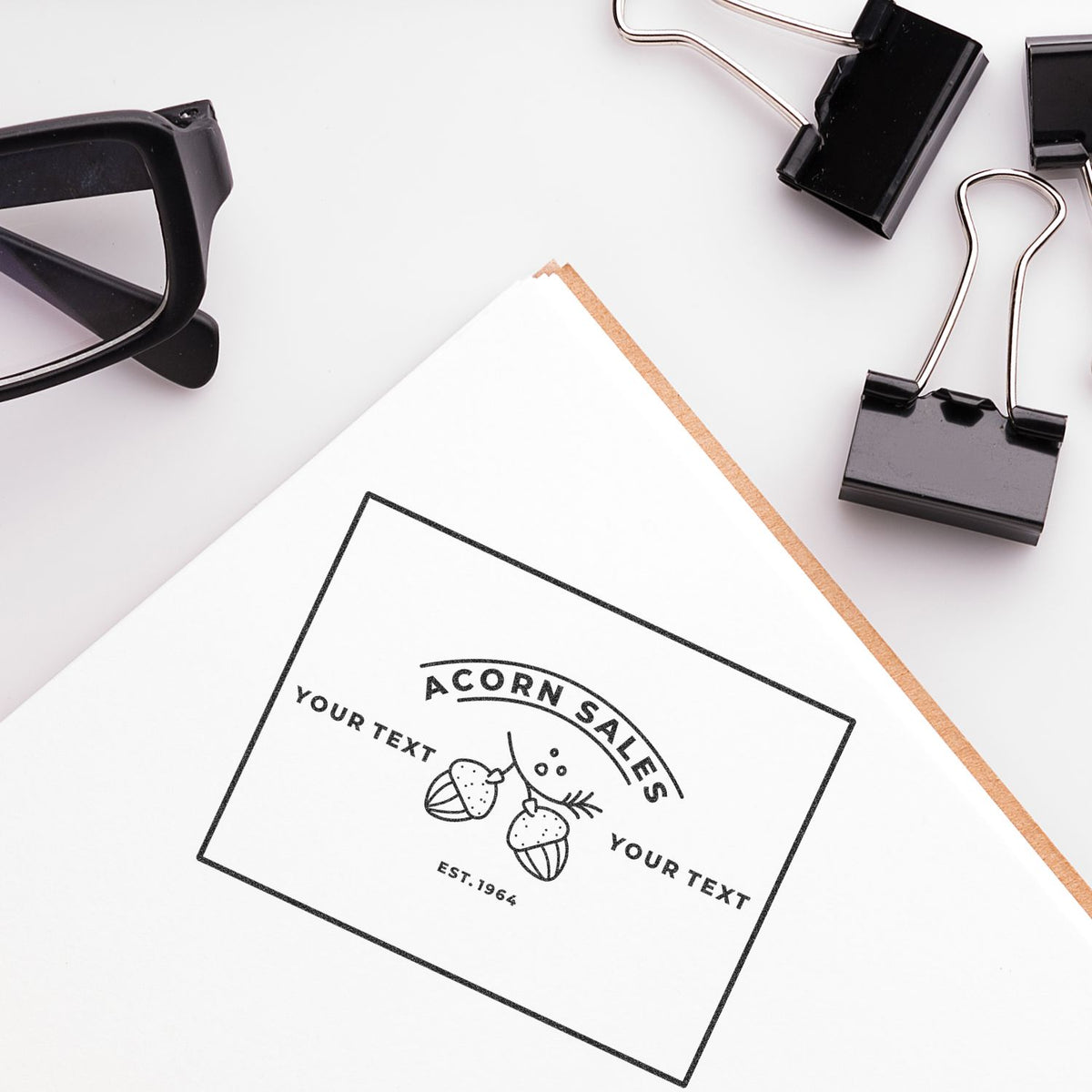 Branding mockup with custom logo business card, acorn sales stamp, and office supplies on white background