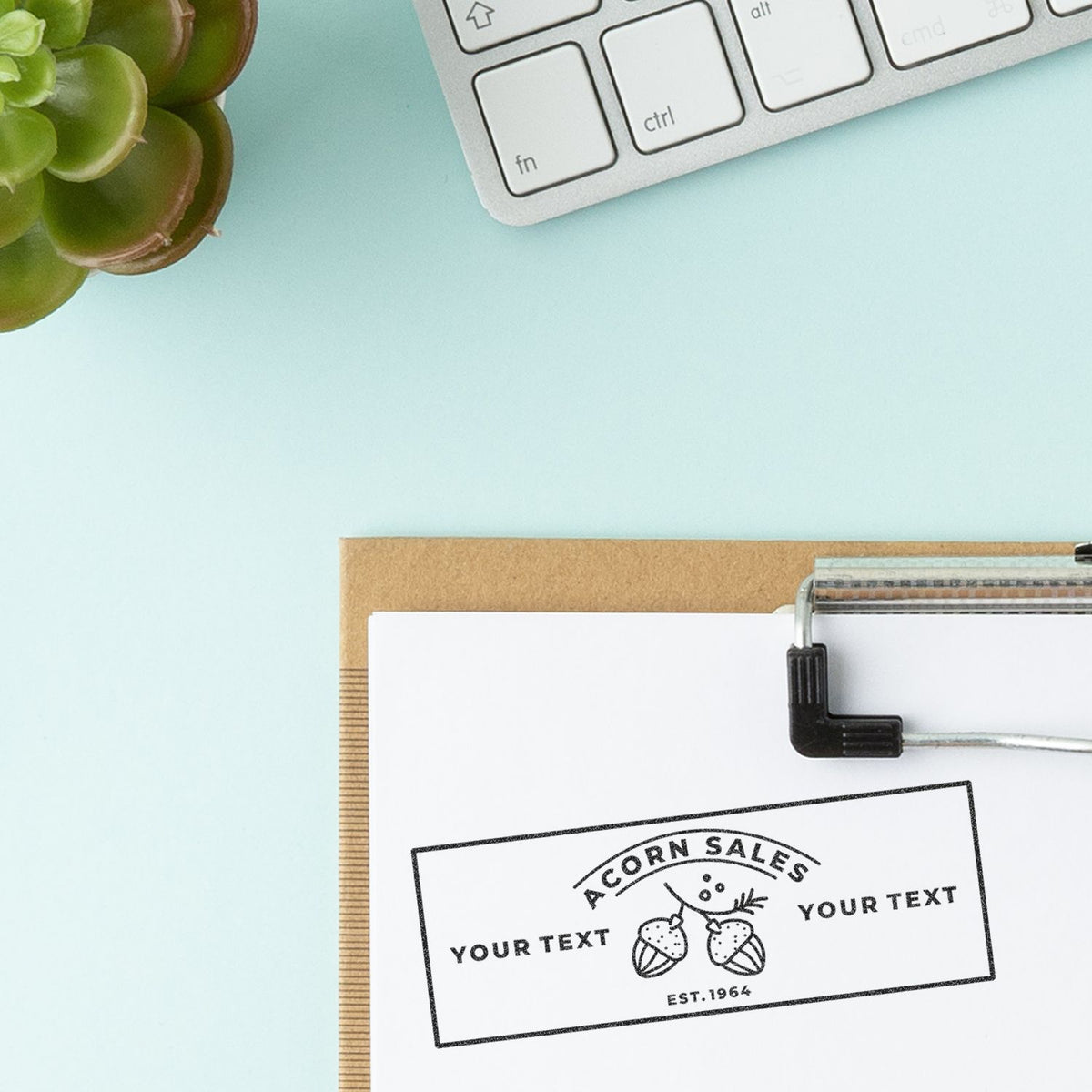 Top view of custom Acorn Sales stamp with Your Text on white card, office branding and printing concept with calculator keys.