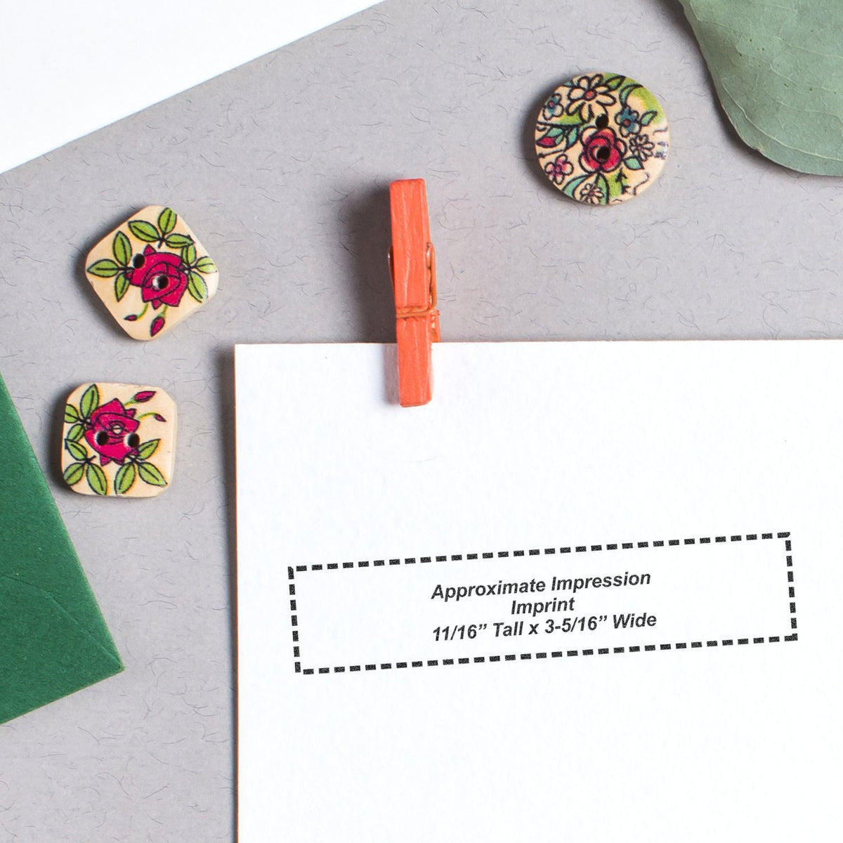 Close-up of floral wooden stamp pieces on craft card, showing approximate impression size 11/16" tall x 3-5/16" wide