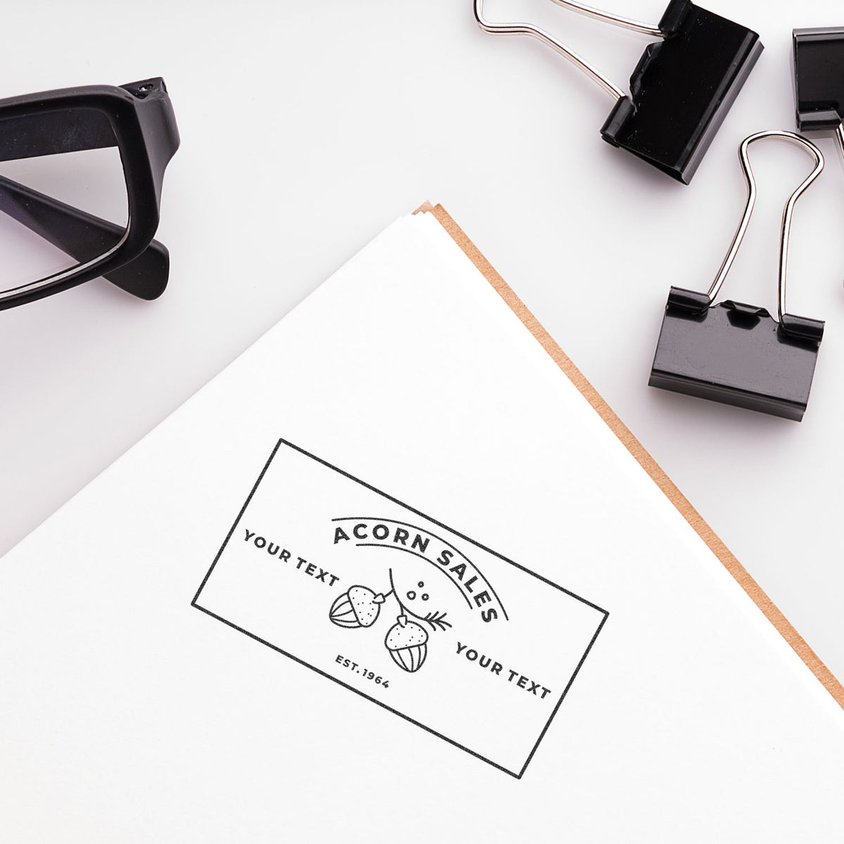 Branding business card mockup with glasses and stationery accessories on white desk, promoting Acorn Sales.
