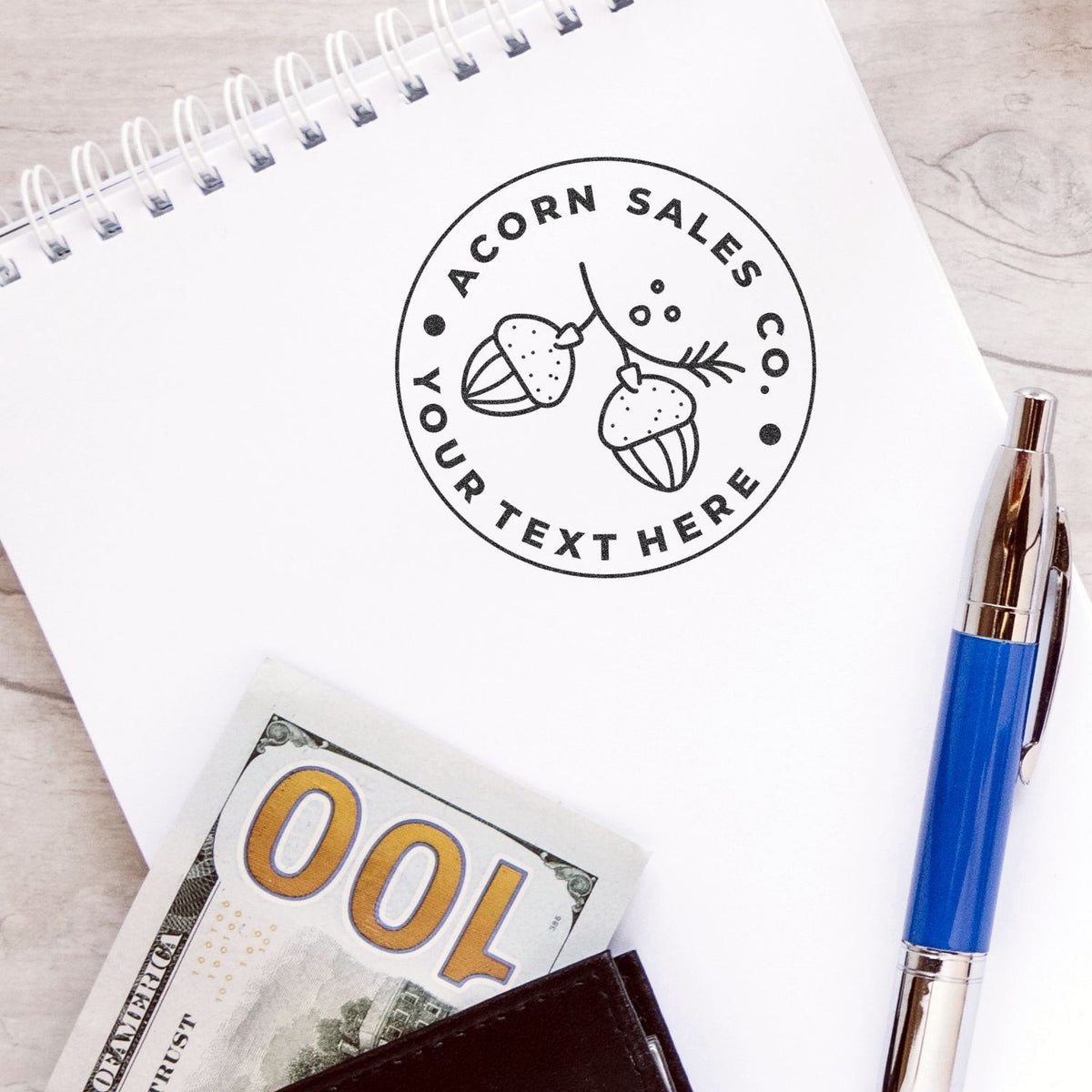 Acorn Sales customer reminder logo on a spiral notebook with 'Your Next Here' text, business stationery for sales branding marketing.