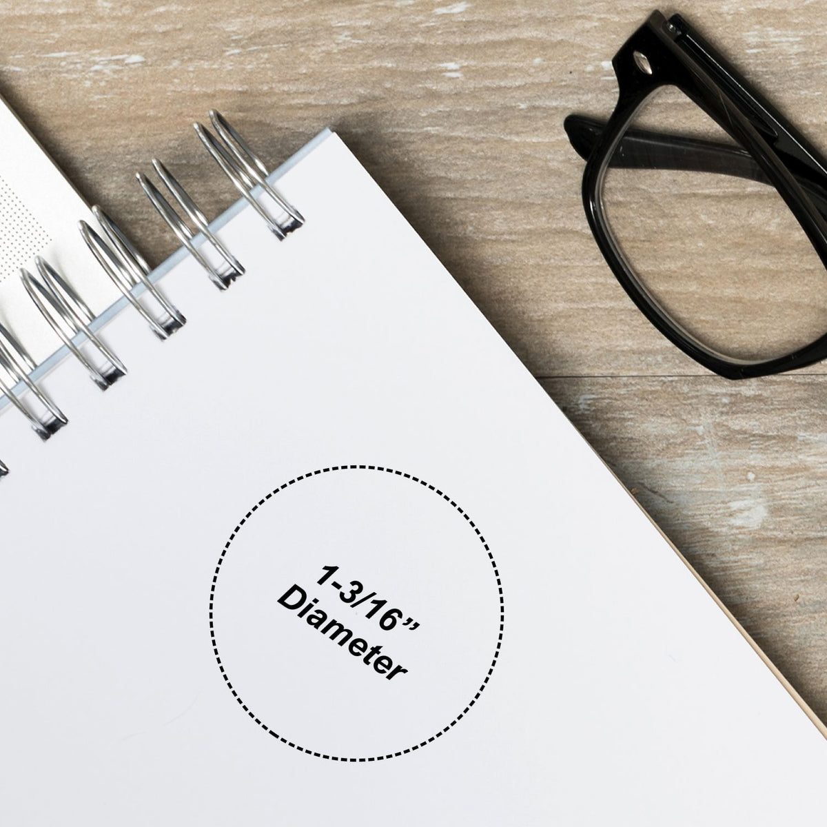 Metal binder clips, black glasses and a labeled Diameter 1-3/8 measurement template on white paper for engineering.
