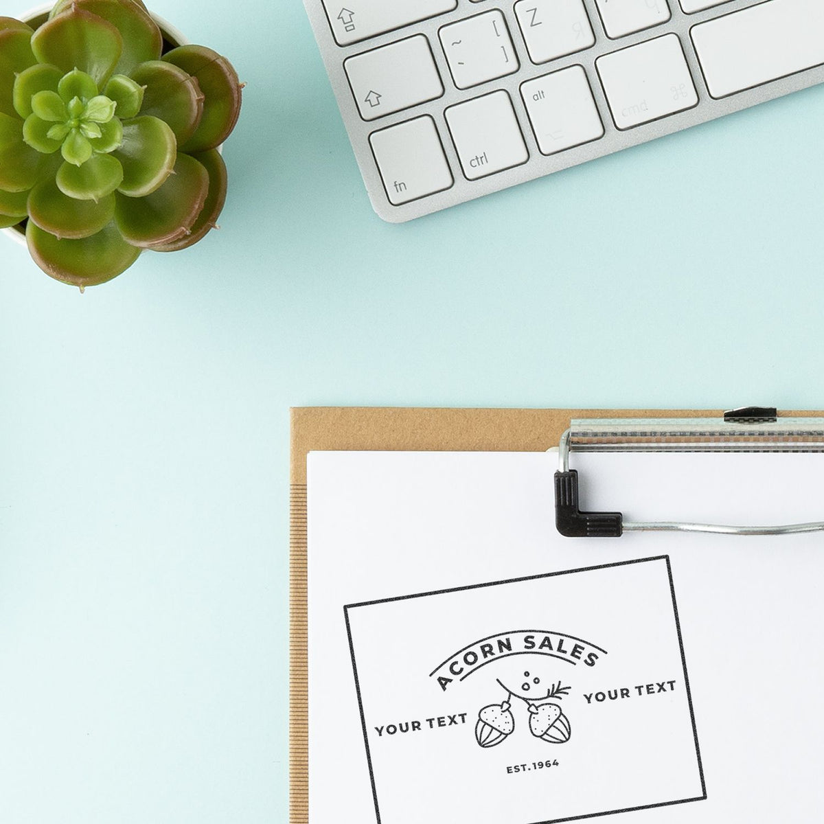 Branding mockup with Acorn Sales stamp on paper, succulent and keyboardcreative design and marketing template background.