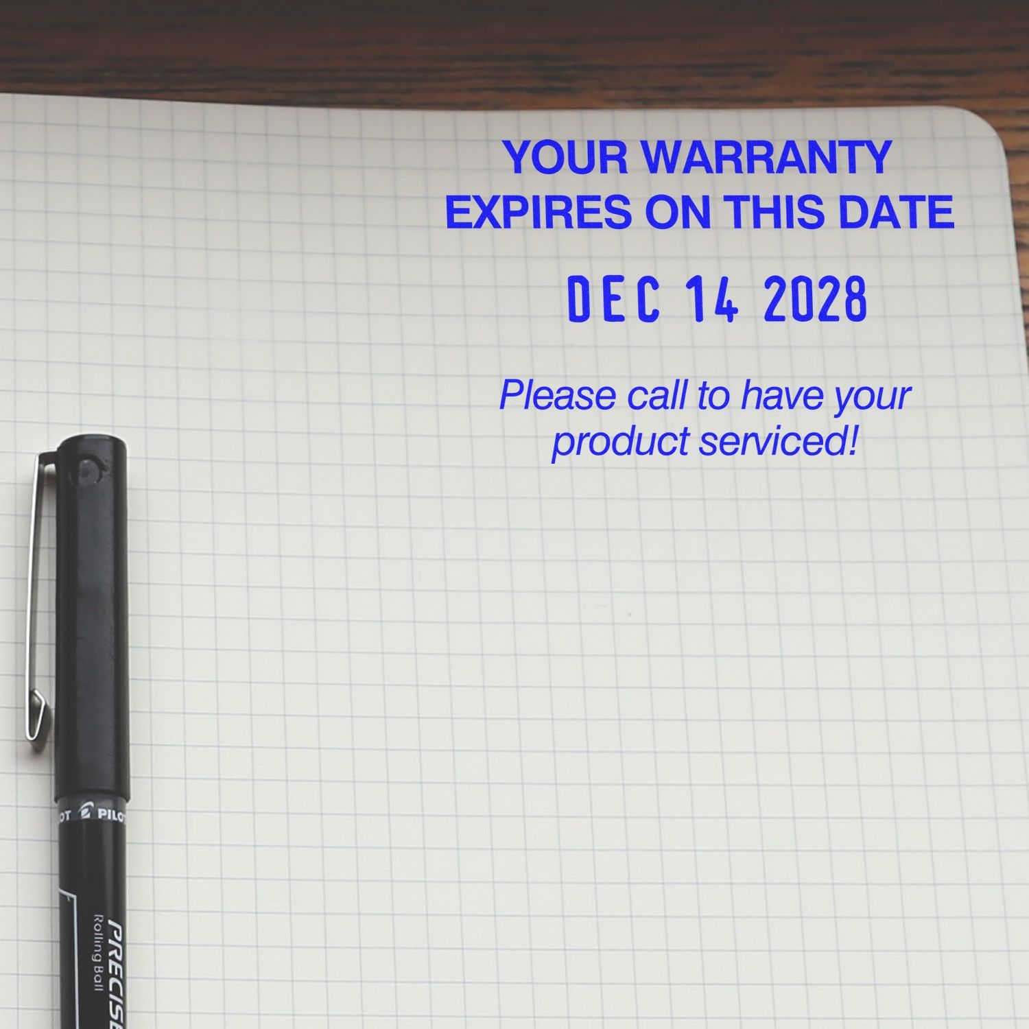 Notebook page with pen showing blue warranty expiration notice: Your warranty expires on this date, Dec 14, 2028 and product service reminder.