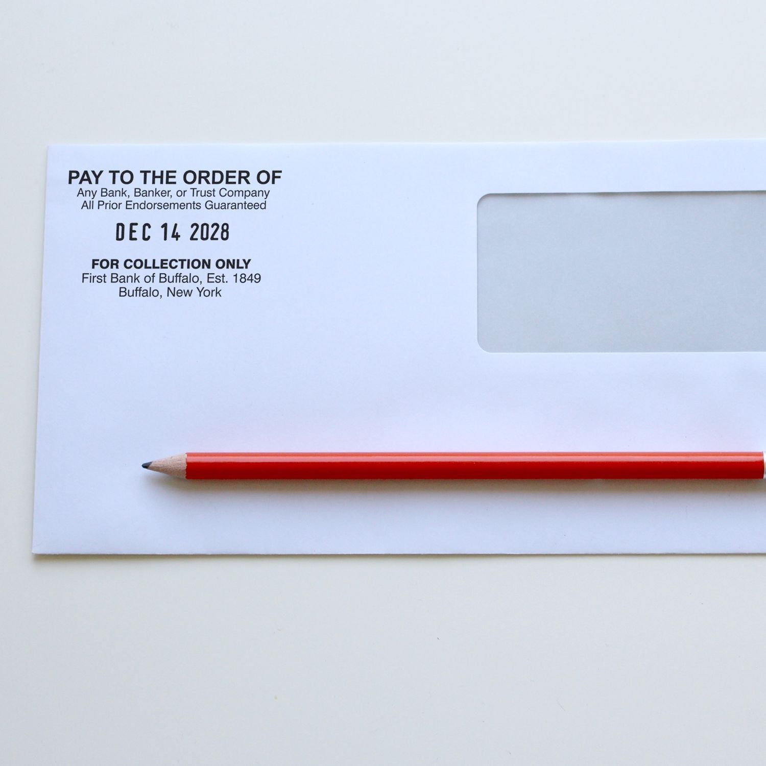 Blank bank check with red pencil on white background, payment order form for business accounting.