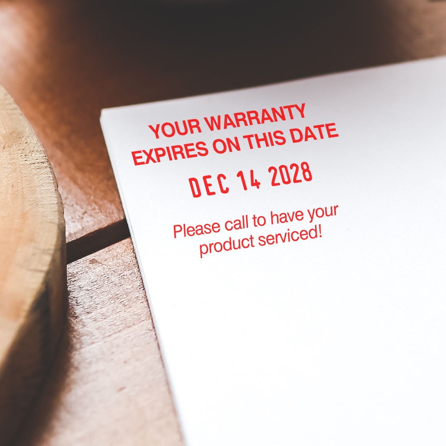 Warranty expiration notice on paper with red text showing expiration date Dec 14, 2028 and product service reminder.