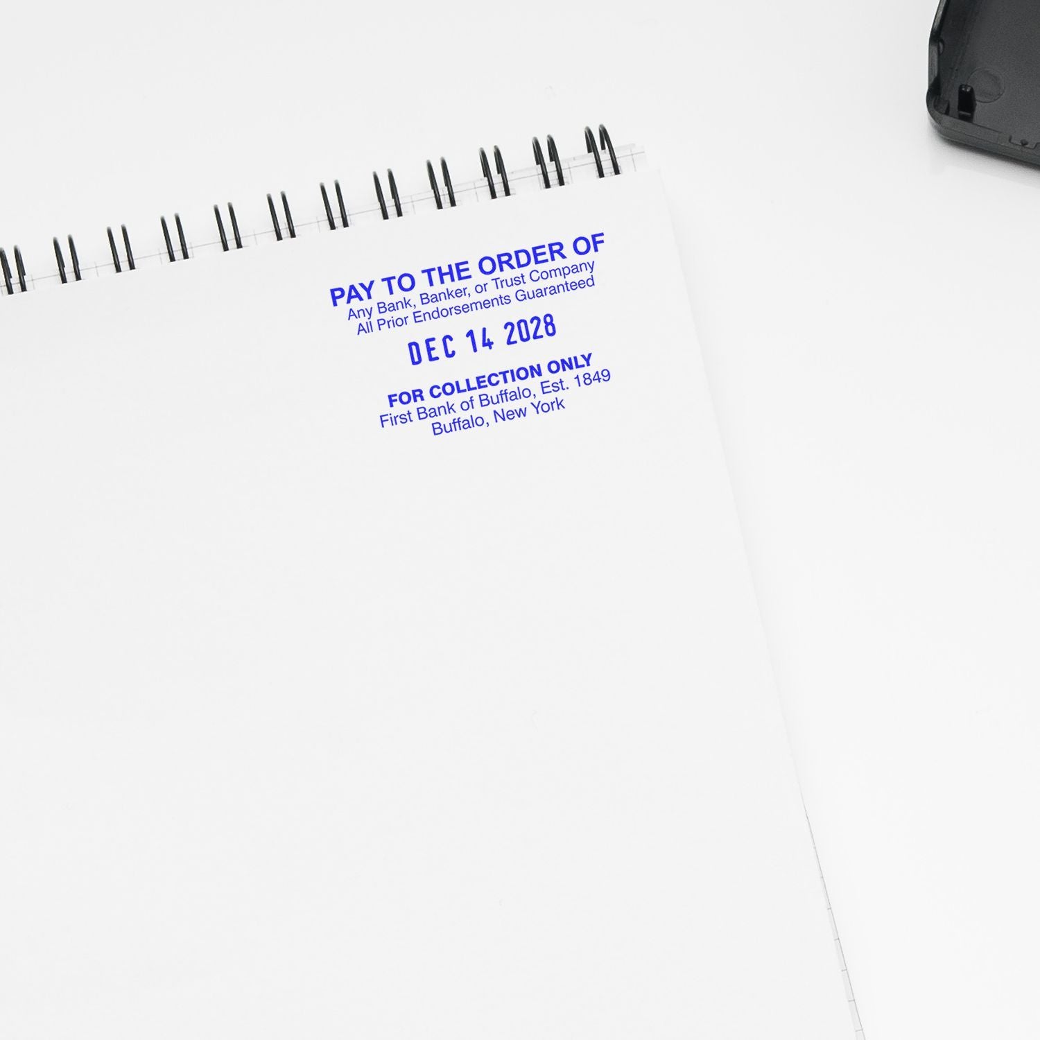 Blank checkbook with blue bank imprint and date stamp on white background, financial document and banking concept.