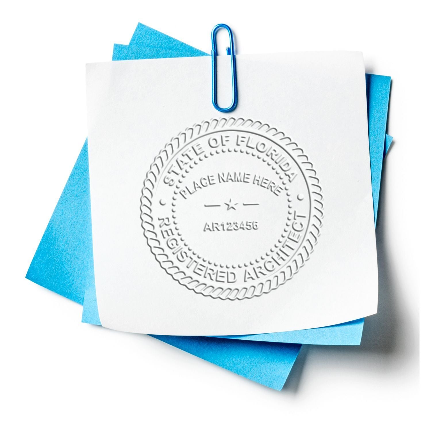 Florida registered architect seal on white paper with blue sticky notes and paperclip.