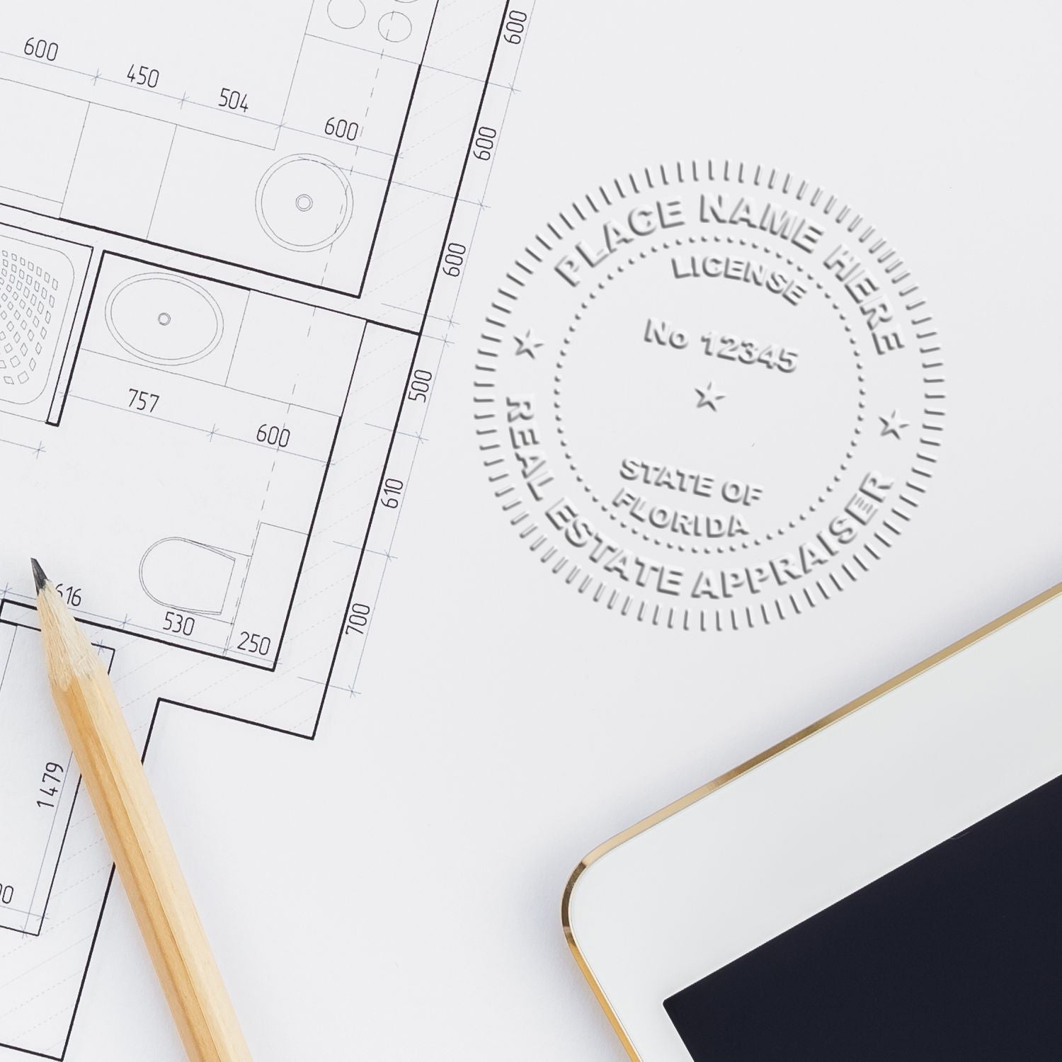 Architectural floor plan blueprint with pencil, tablet, and Florida real estate appraisal seal