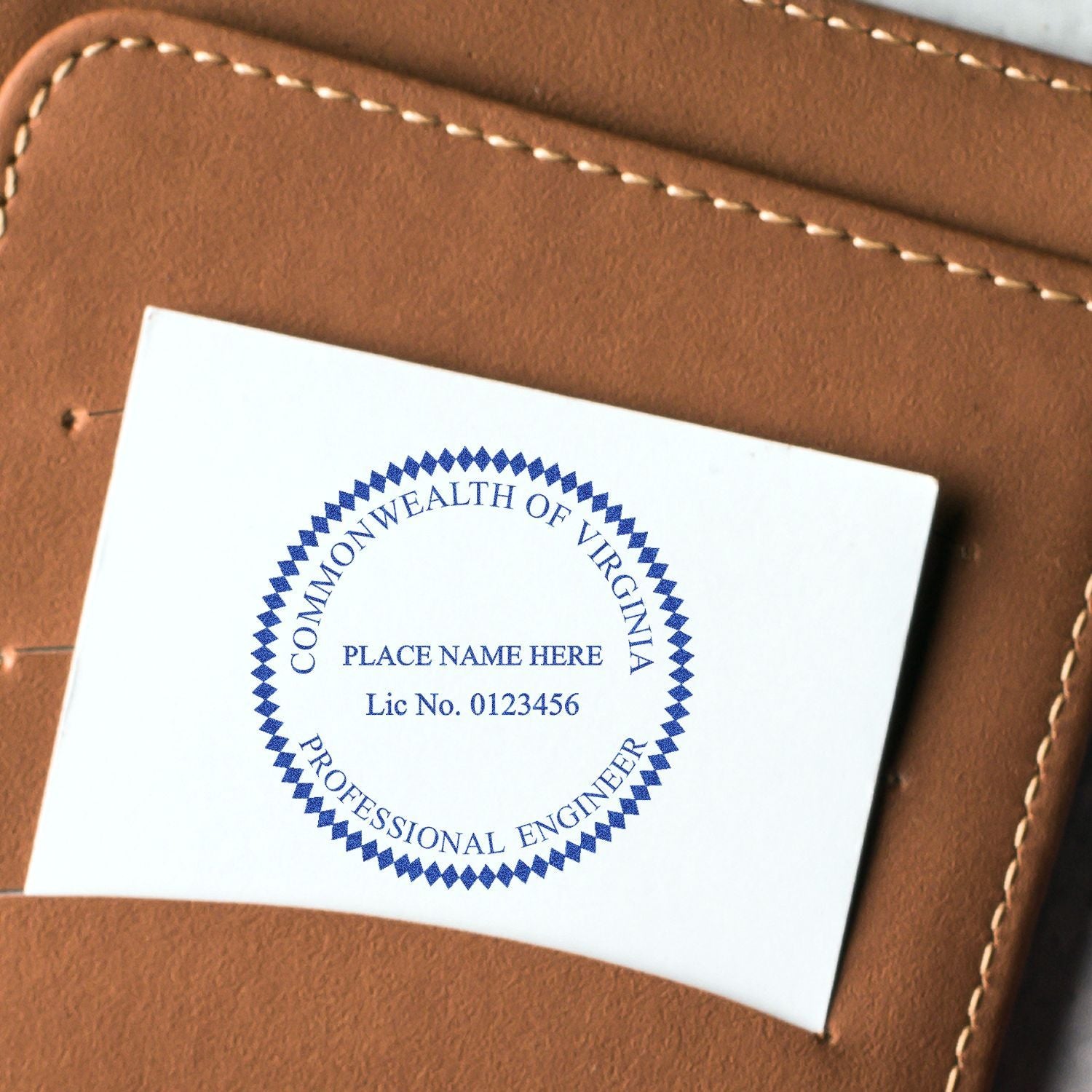 Commonwealth of Virginia Professional Engineer license seal card on brown leather background