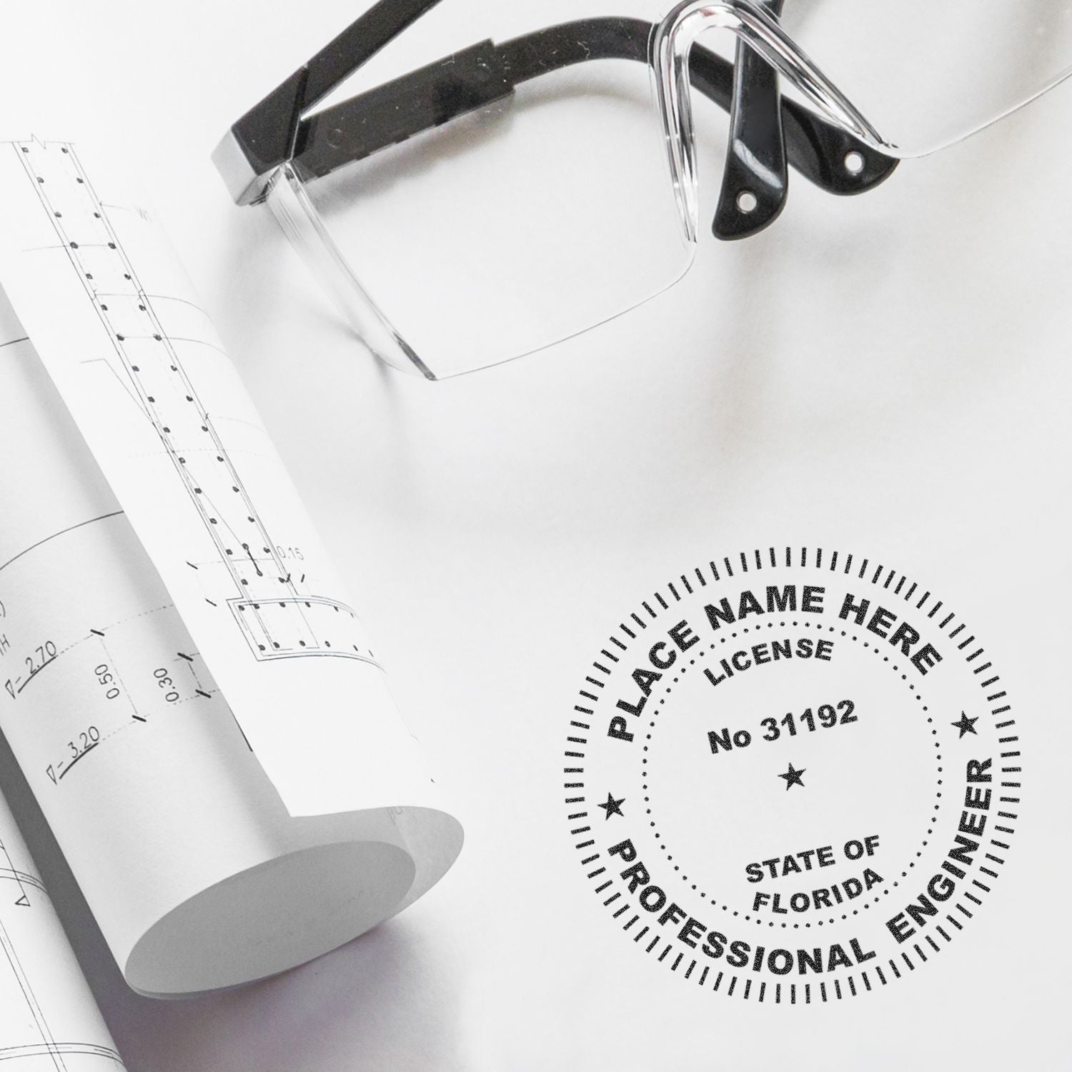Architectural blueprints with safety glasses and Florida professional engineer license seal on a desk