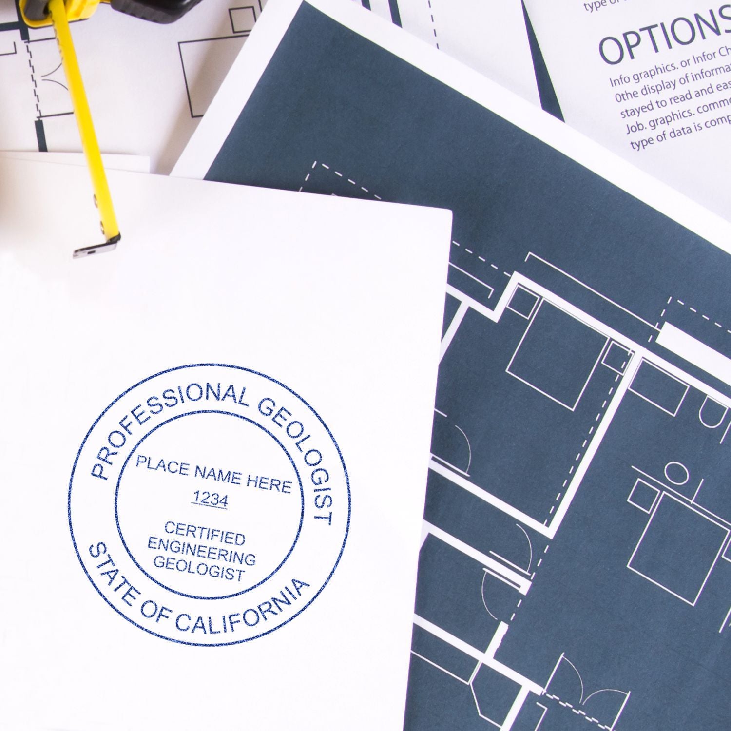 Professional geologist seal on blueprint plans with engineering drawings and pencil, California geology certification document.