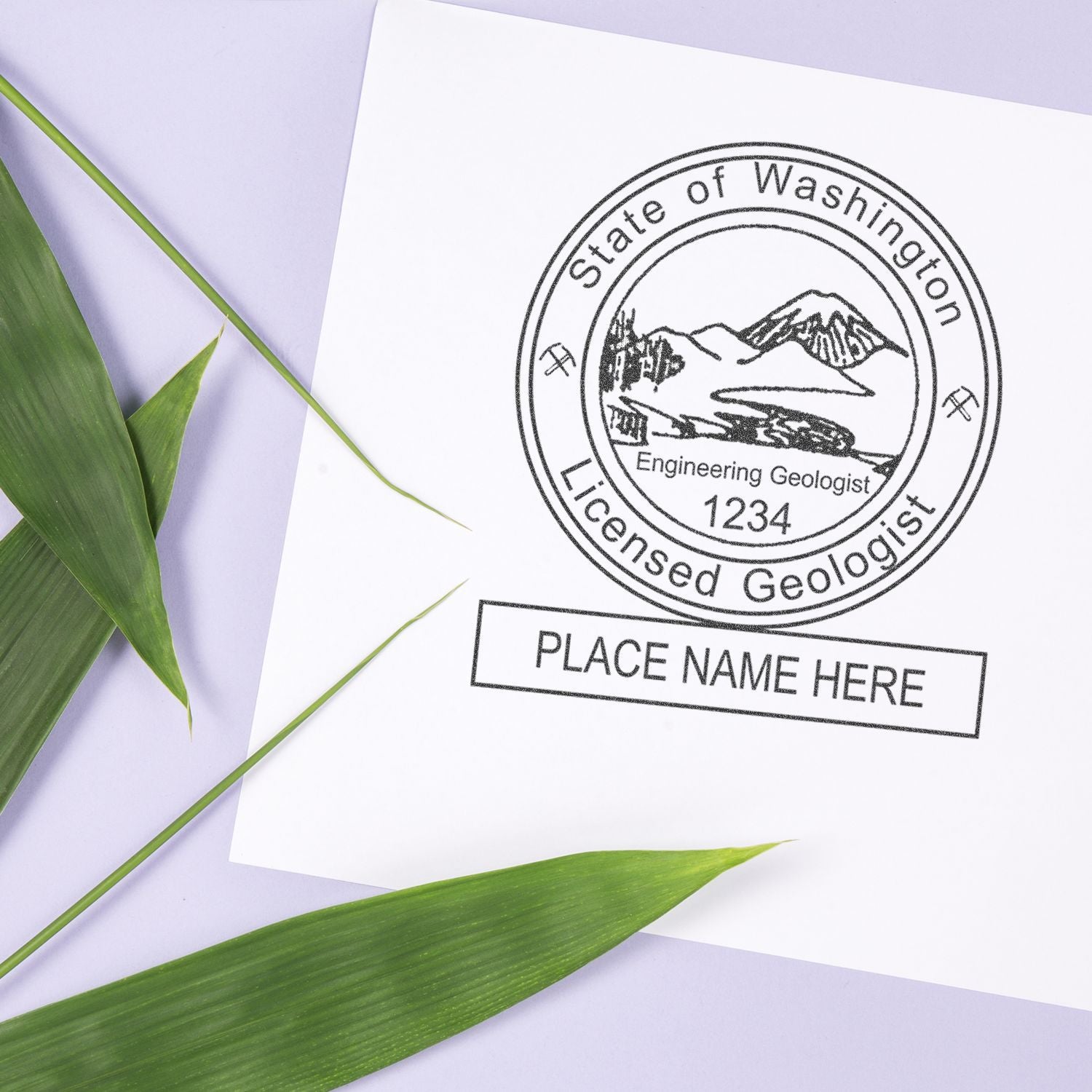 State of Washington Licensed Geologist stamp on paper with green leaves and Place Name Here label.