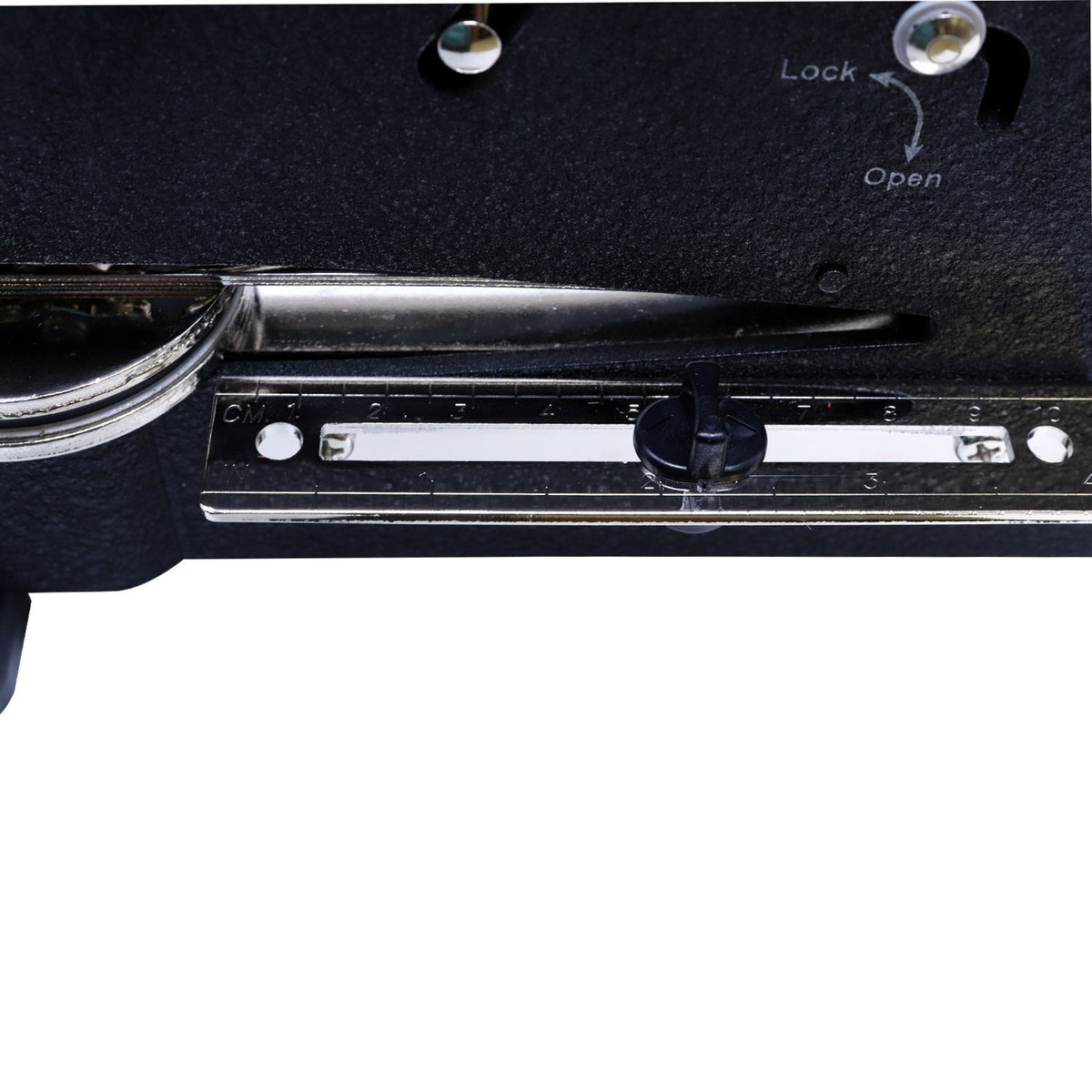 Close-up of a sewing machine stitch length selector with lock and open markings, metal adjustment scale, and control slider.