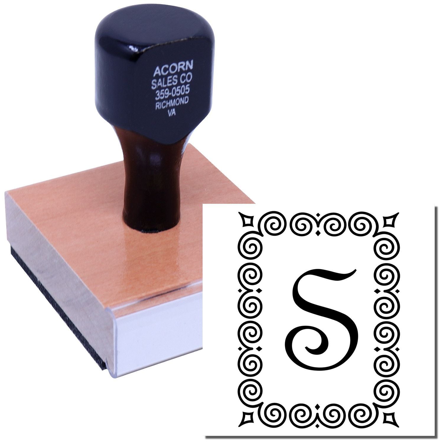 Custom rubber stamp with ornate letter S monogram, shown on ink pad for personalized stationery or branding.