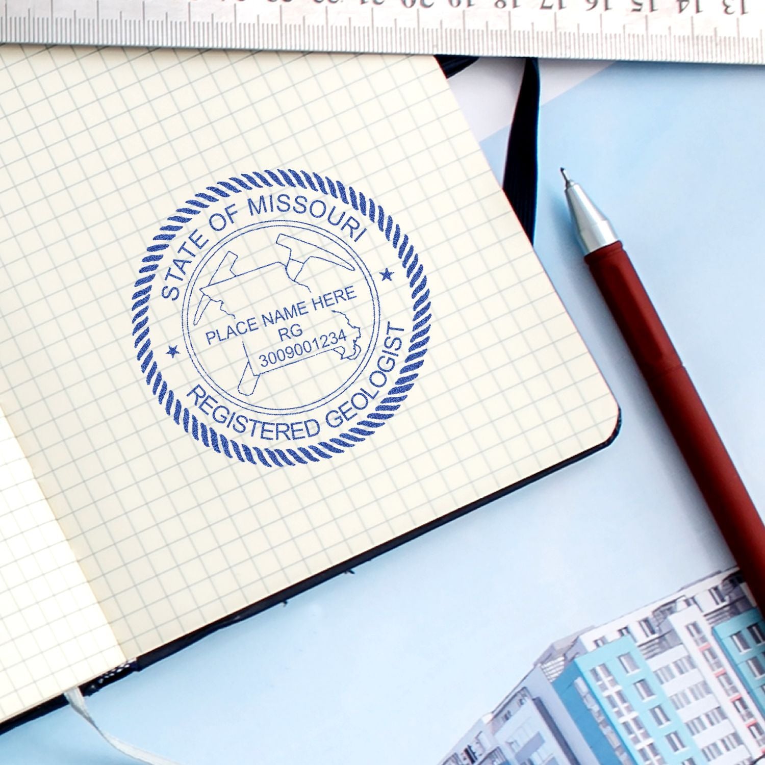 Missouri registered geologist stamp on graph paper notebook with pen, ruler, and blueprint workspace.