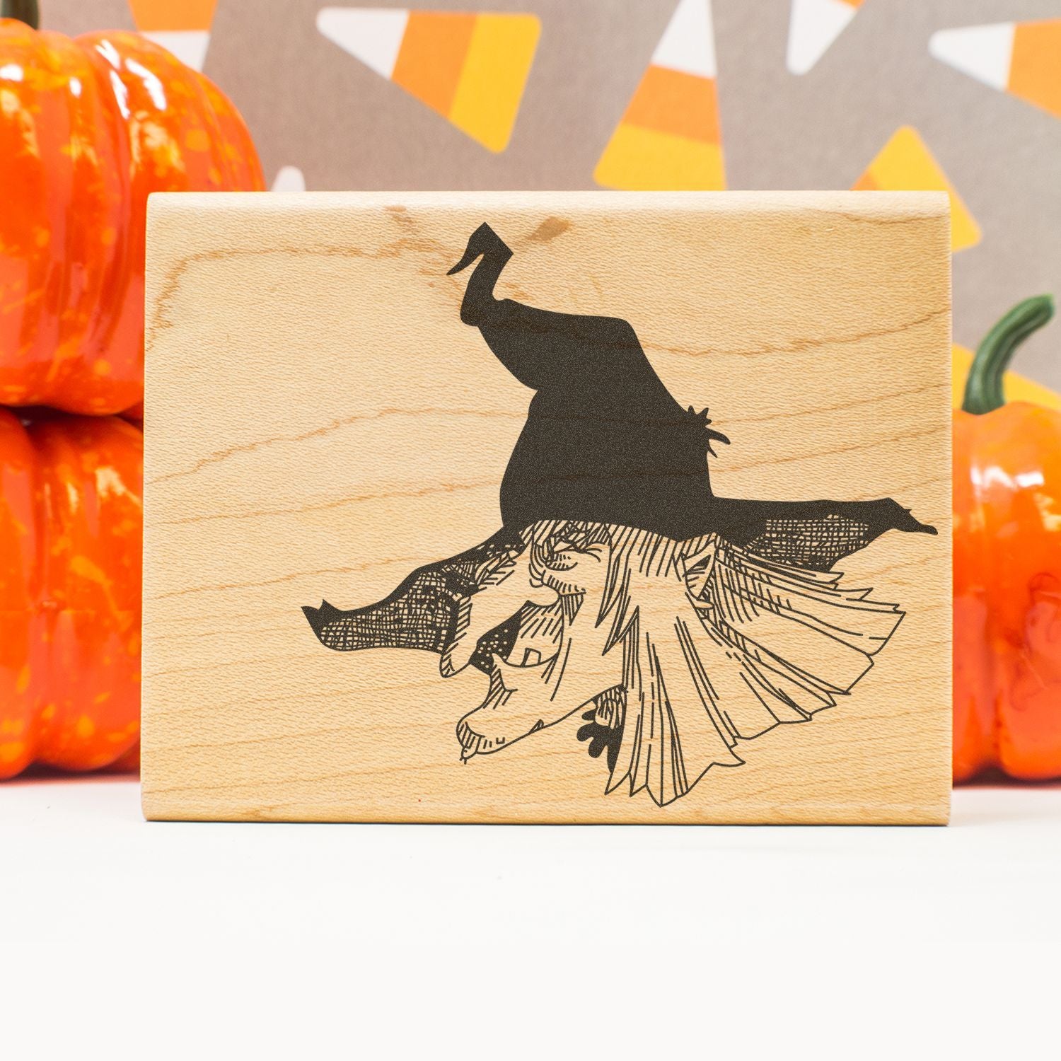 Wooden Halloween witch silhouette sign with pumpkins and autumn fall decor background
