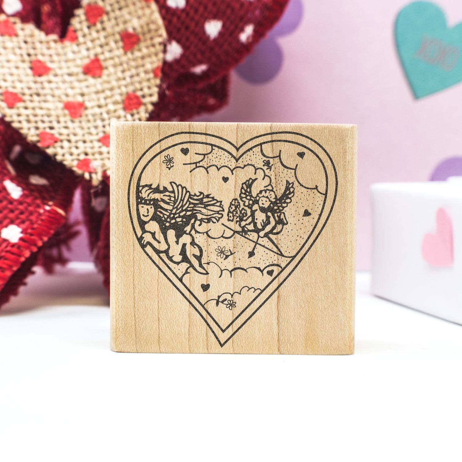 Heart-shaped wooden rubber stamp with cupid and cherub design for Valentines Day crafts and romantic DIY projects