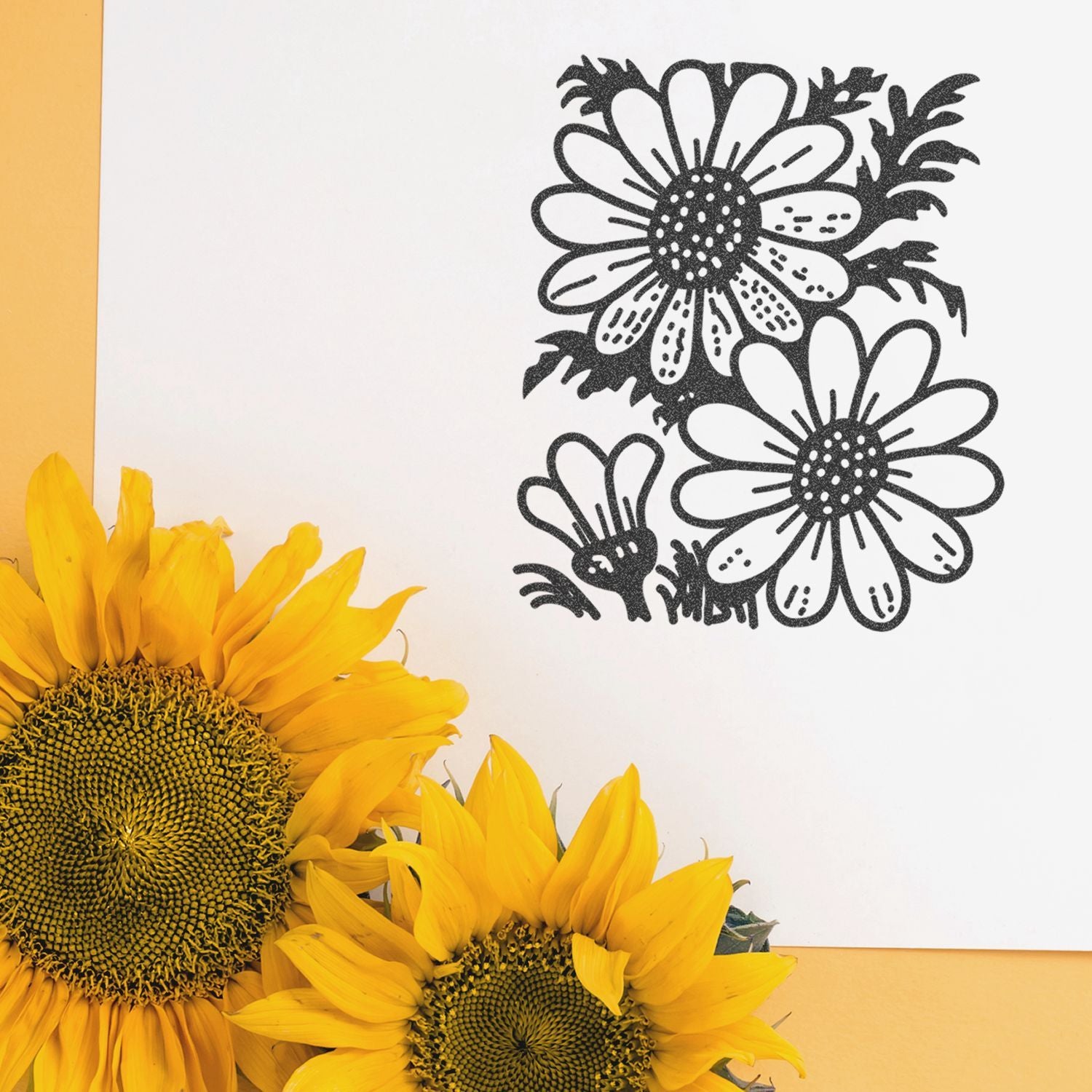 Bright yellow sunflowers with black floral line art on a white background, creating a cheerful botanical design.