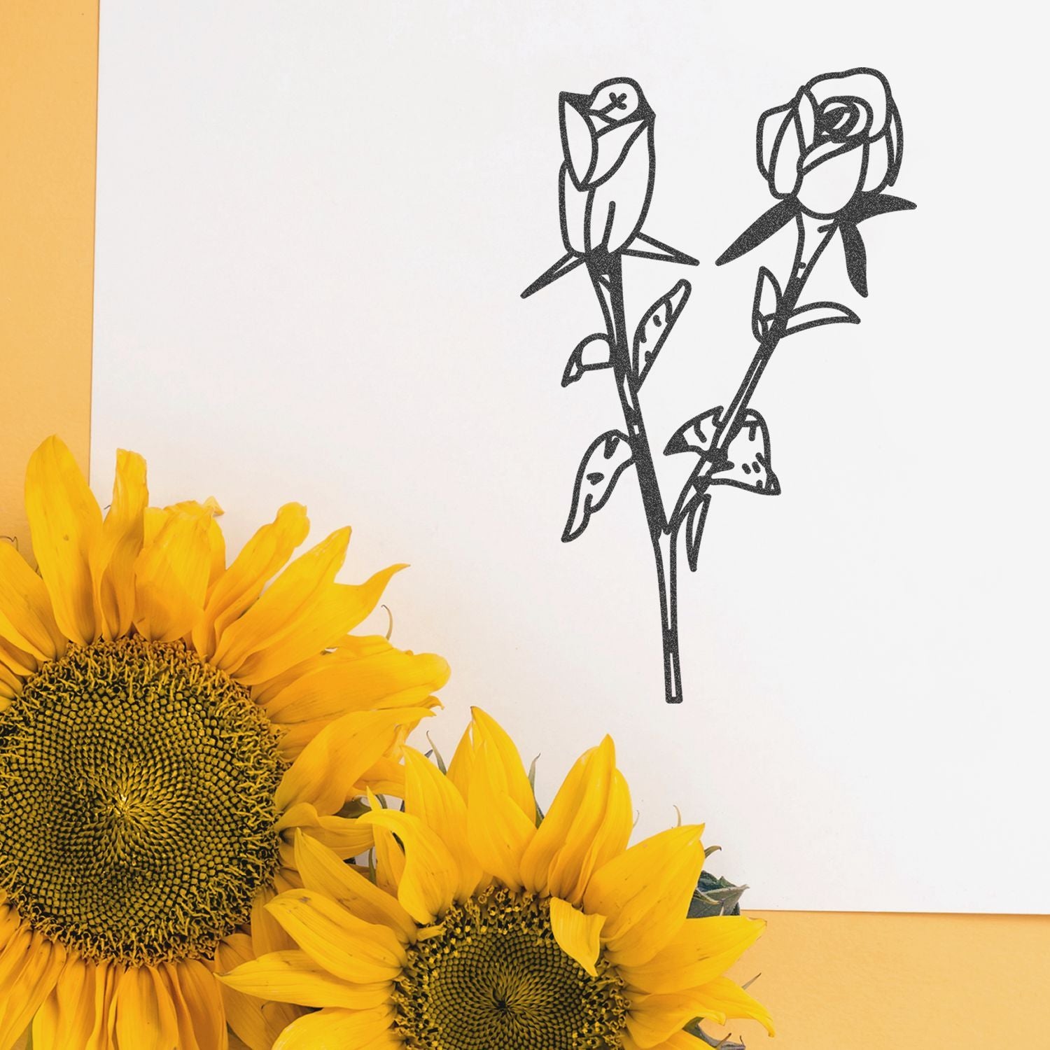 Bright yellow sunflowers with minimalist black rose line art on a white background, elegant floral still life.