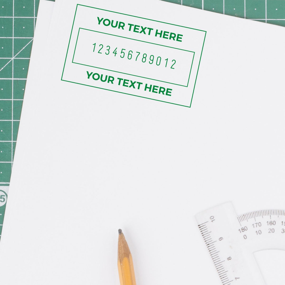 DIY craft template on cutting mat with Your Text Here label and number placeholders, pencil and ruler for custom design work