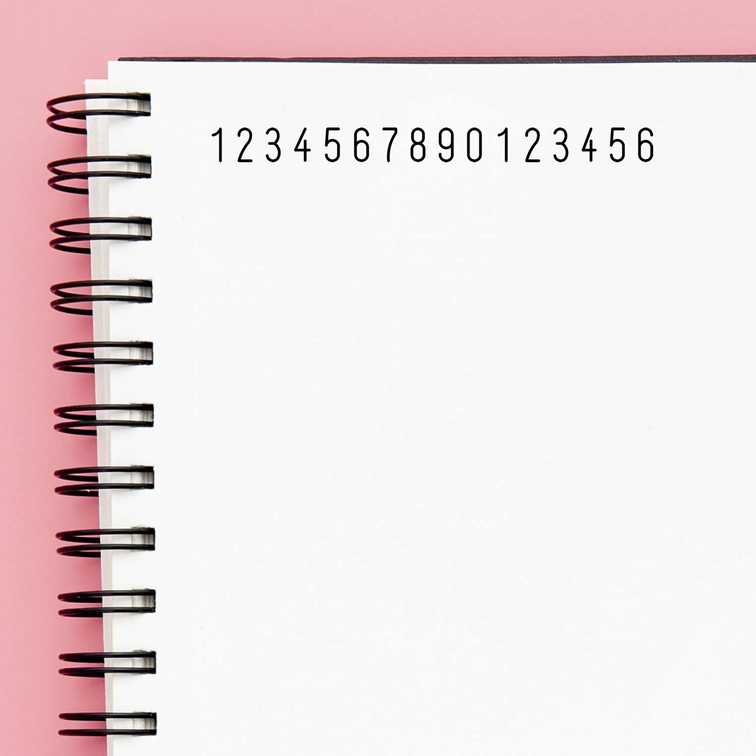Spiral notebook page showing the number sequence 1234567890123456, ideal for counting and math practice for kids math education and arithmetic drills.