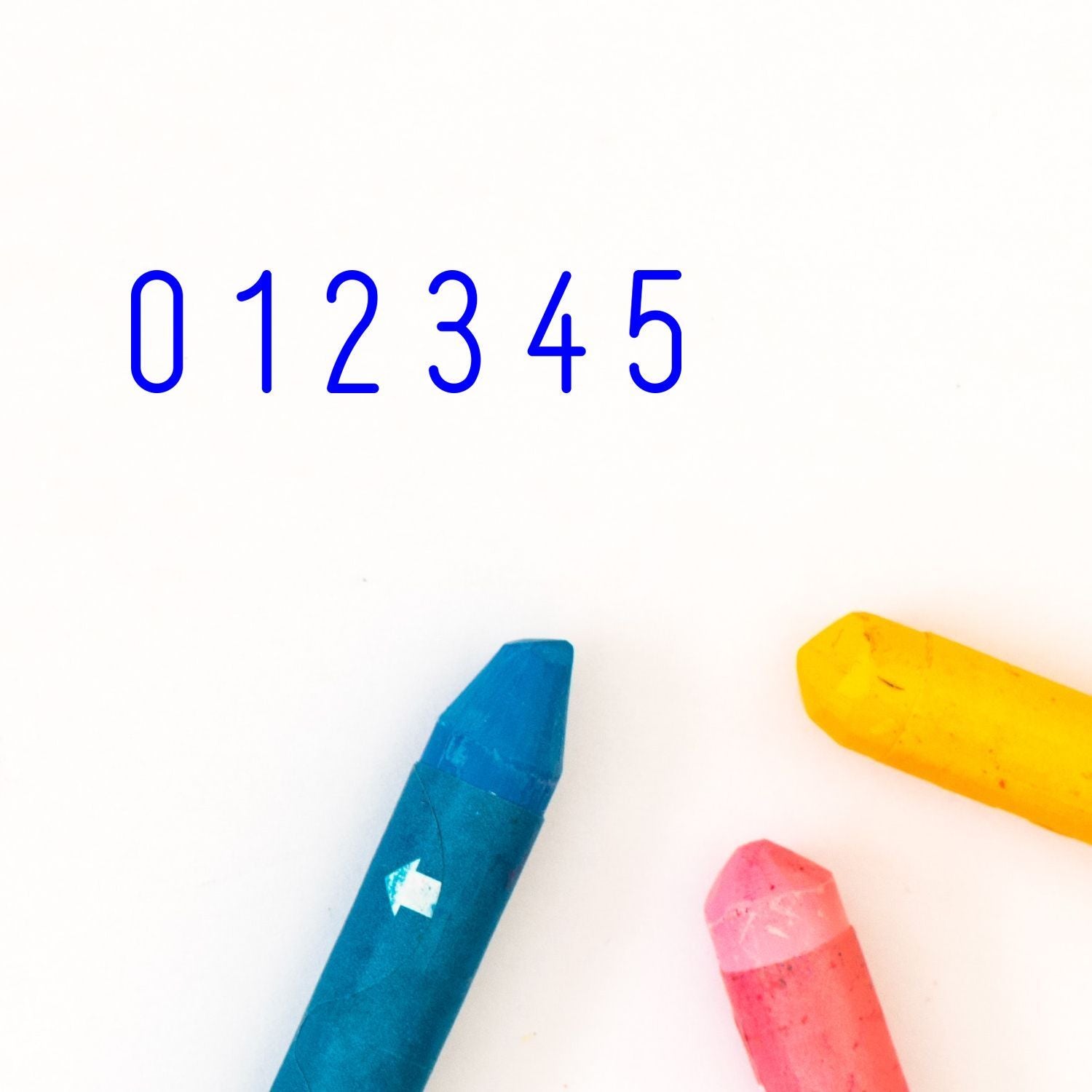 Blue 012345 numbers with colorful crayons on a white background, minimalist educational abstract design.