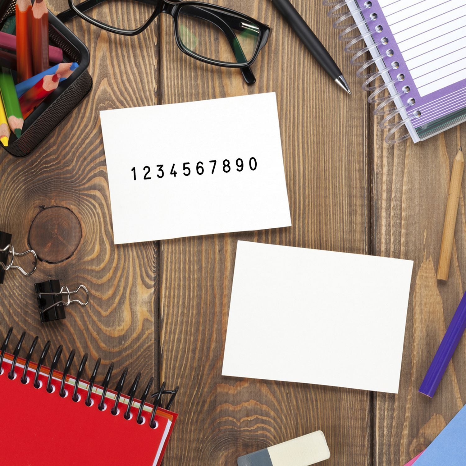Desk learning supplies with blank notes and number sequence 1234567890, showing math practice and study planning on wooden surface