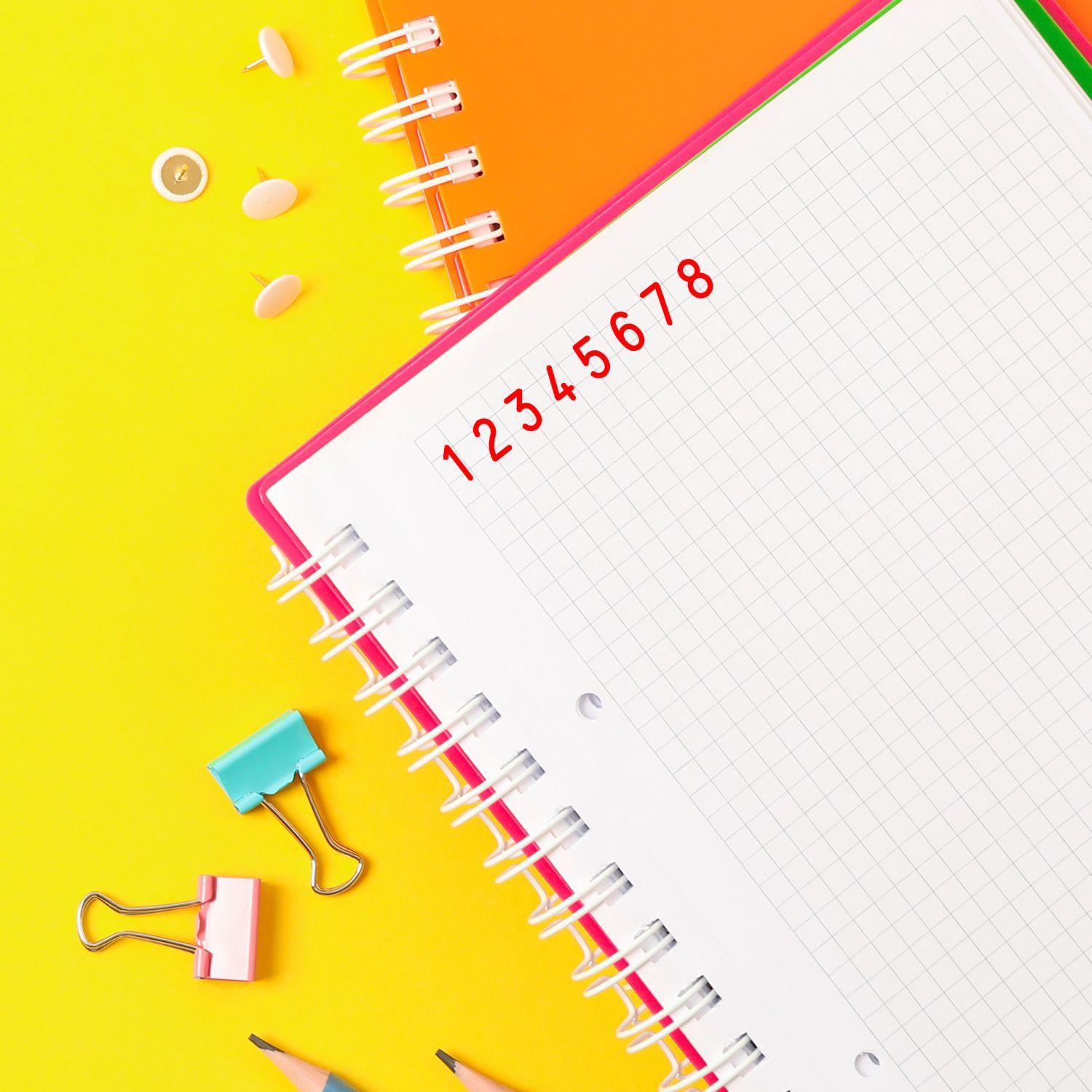 Spiral notebook page with handwritten numbers 18 and colorful stationery, illustrating math study and lesson planning on yellow background.