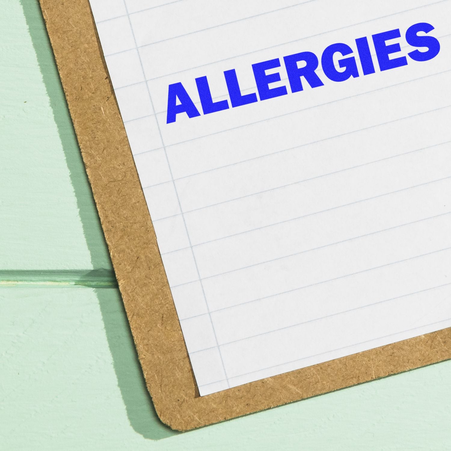 Clipboard with paper labeled ALLERGIES on a pastel background, concept for allergy information and medical notes